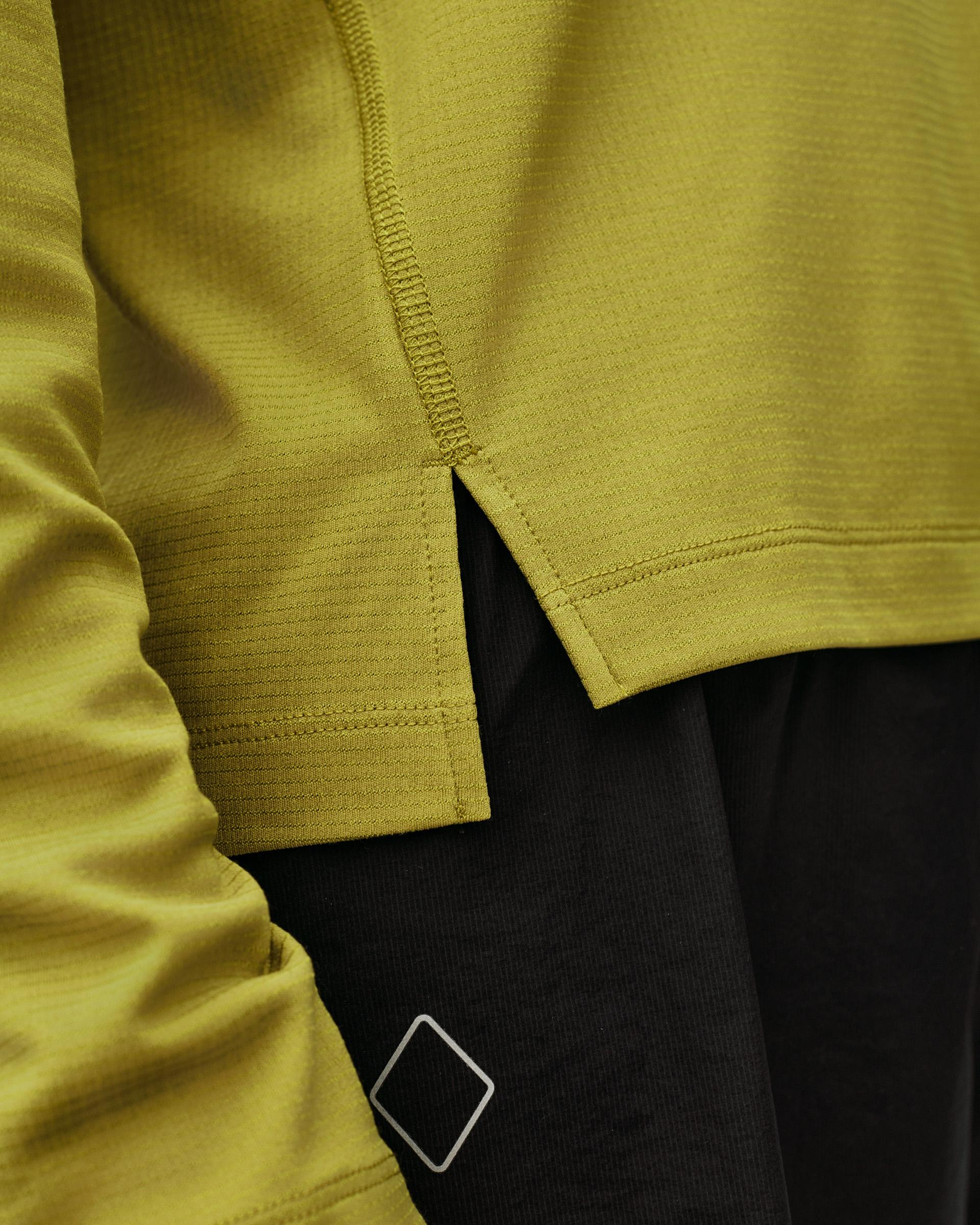 Dark Lime green Balance women's long sleeve T-shirt, detail view showing hem vent and side zip