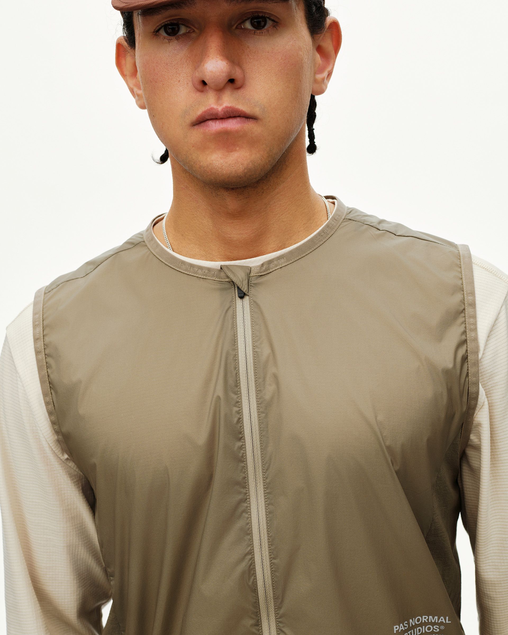 Dusty Earth khaki Balance Windproof vest on model, front detail with centre zip and collarless neckline