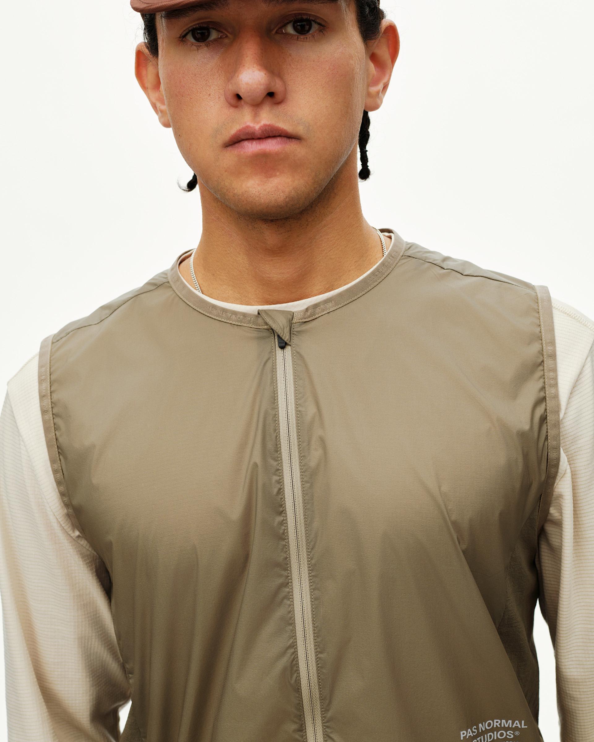 Dusty Earth khaki Balance Windproof vest on model, front detail with centre zip and collarless neckline