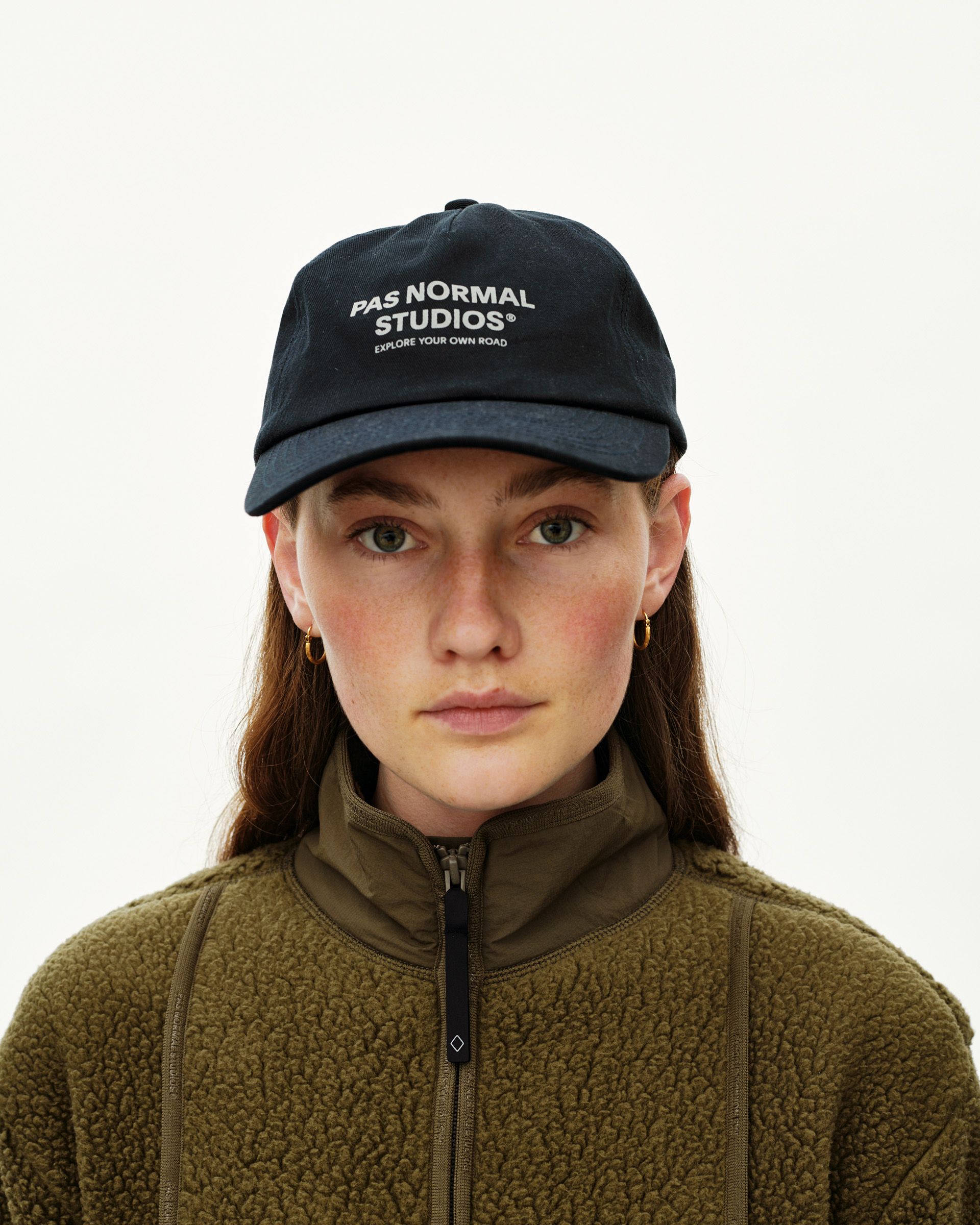 Black Off-Race Cotton cap on model, front view with white logo print on crown