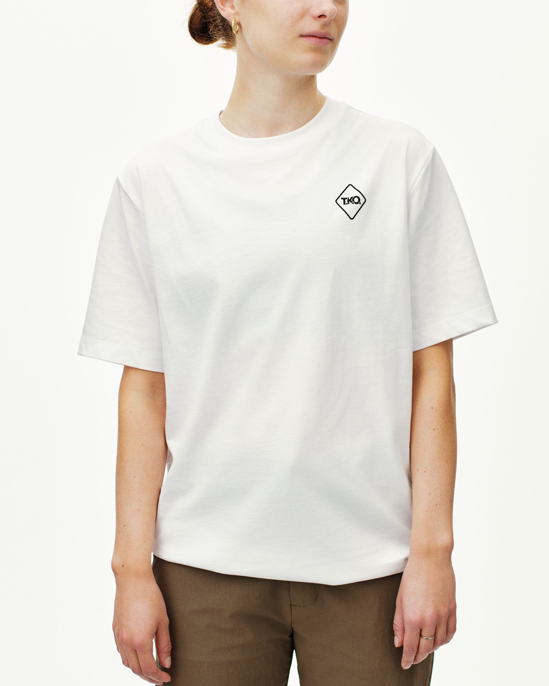 White T.K.O. Off-Race Graphic T-shirt on model, front view with black diamond chest logo patch