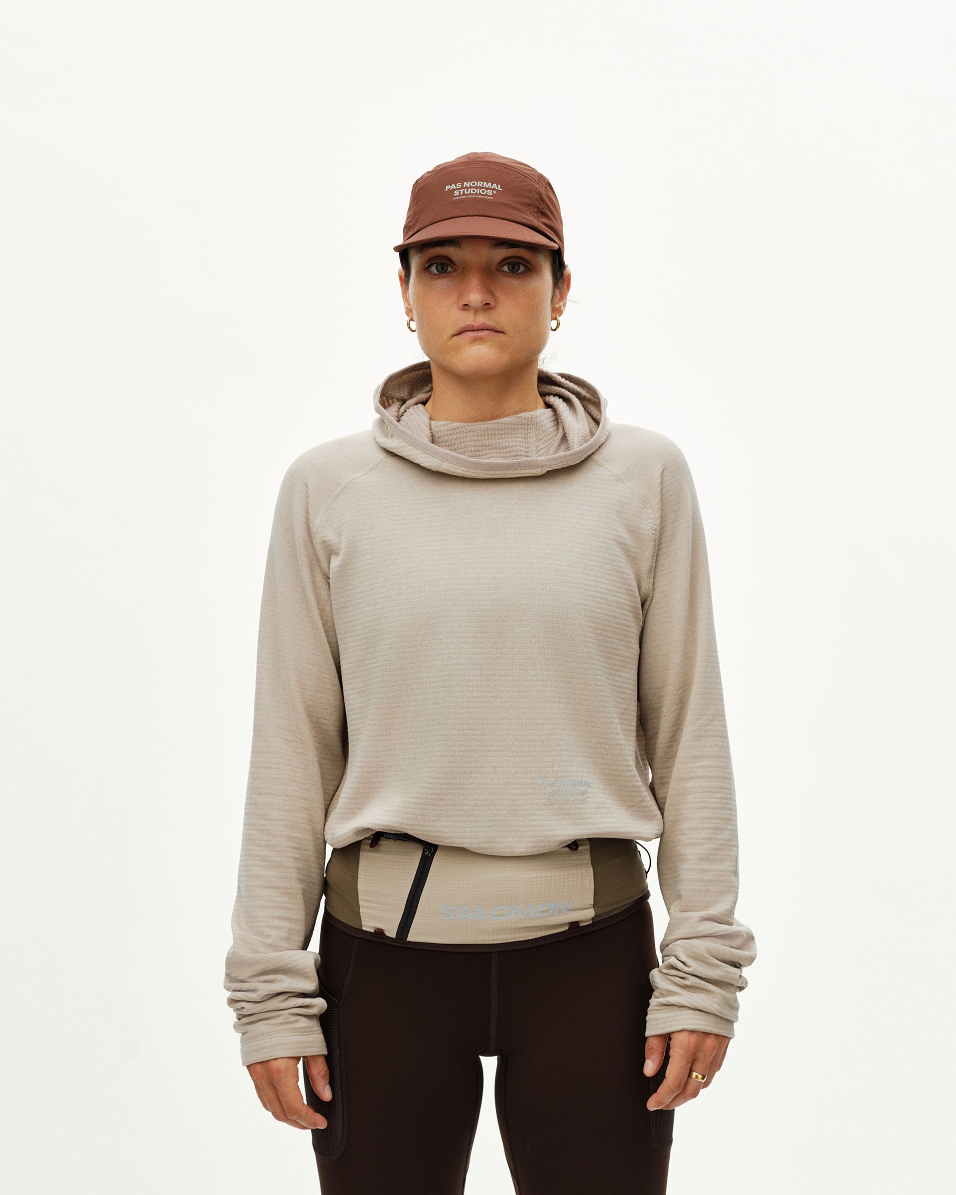 Light Brown Salomon S/LAB Belt worn on model, front view with olive ripstop body and zip pocket