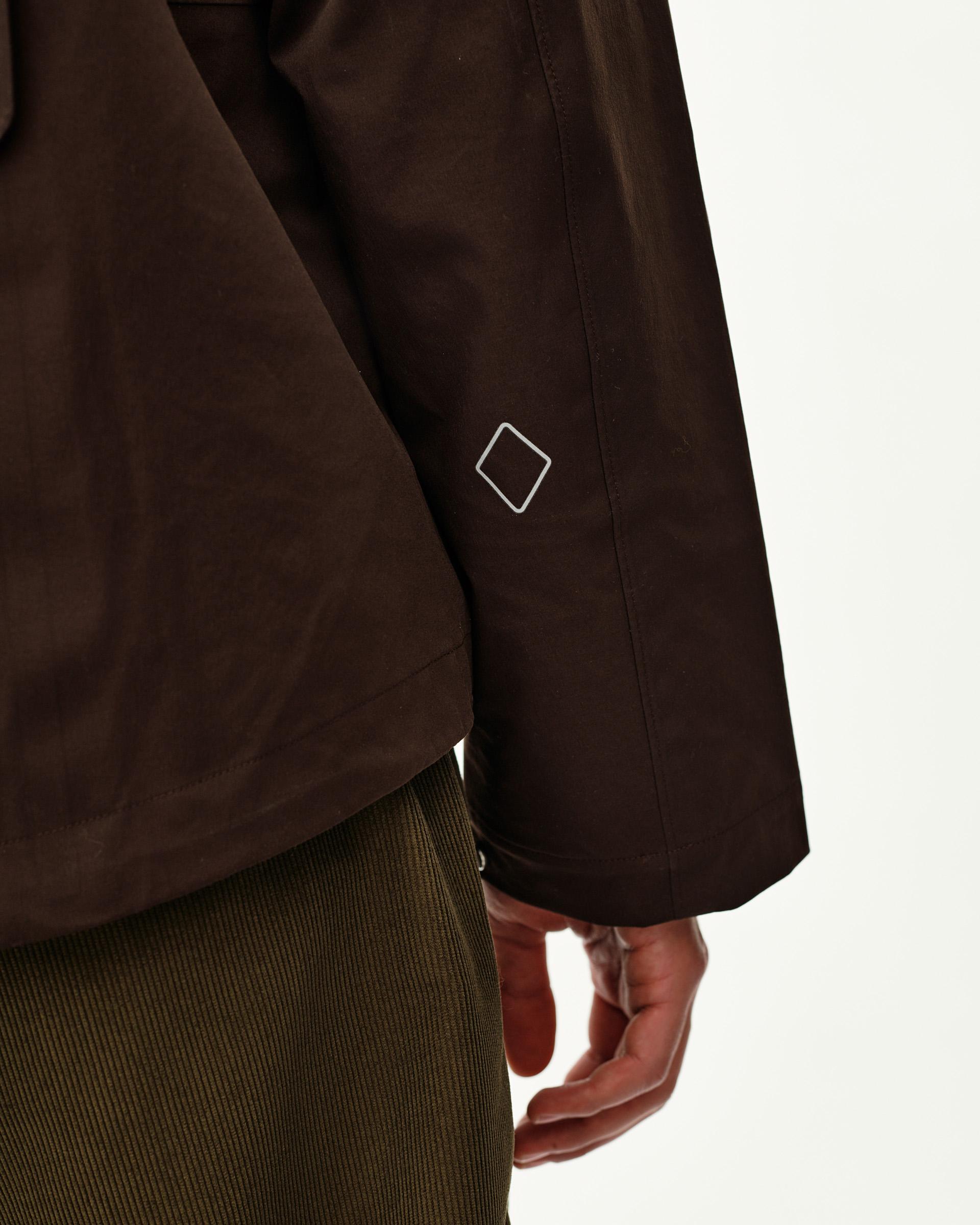 Dark Coffee brown Off-Race 3L Shell jacket, side detail on model showing sleeve with diamond logo print