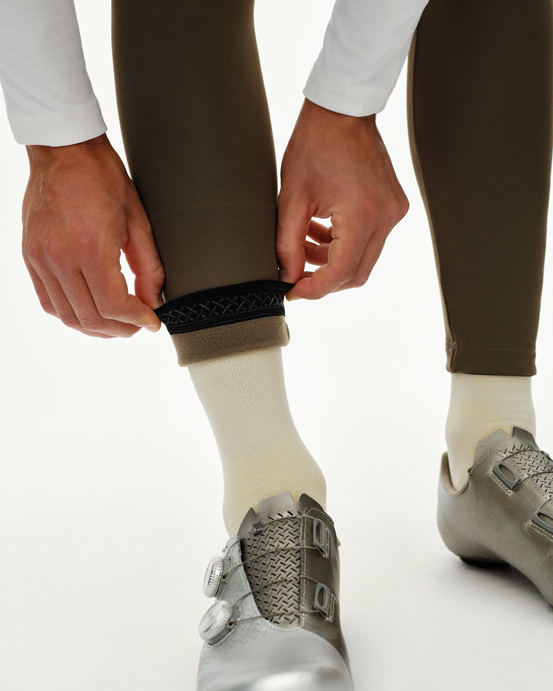 Dark Earth khaki PAS Mechanism Thermal Long cycling bibs, detail on model showing fleece-lined ankle cuff