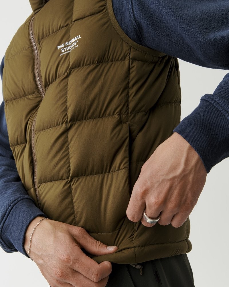 Brown Off-Race Down vest on model with quilted construction and white chest logo