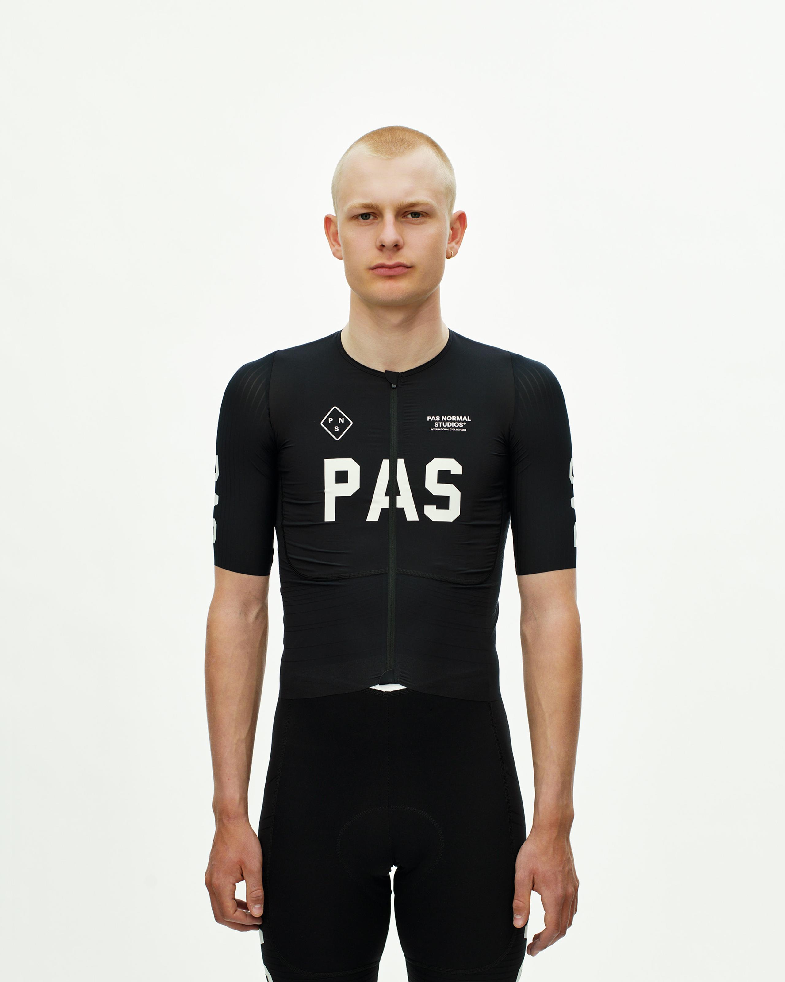 Black PAS Mechanism Pro cycling jersey on model with white chest logo and full front zip