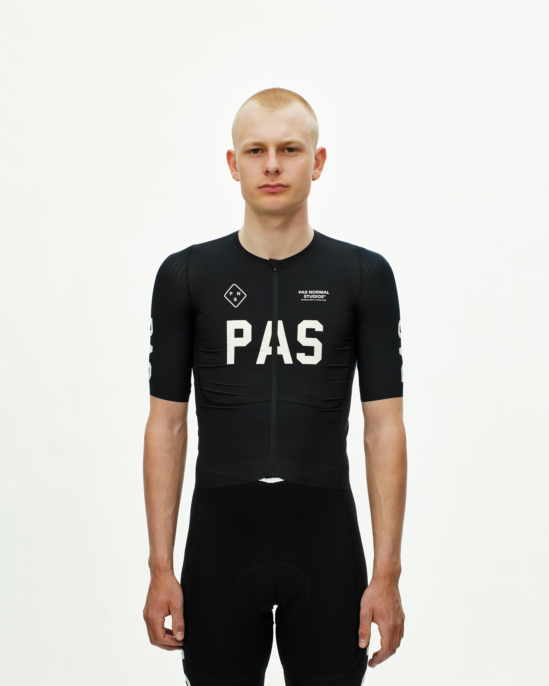 Black PAS Mechanism Pro cycling jersey on model with white chest logo and full front zip