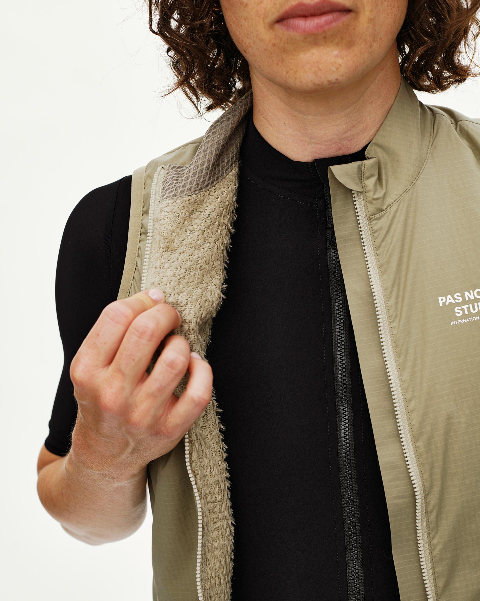 Grey Sage Essential cycling gilet on model, front detail view with fleece inner lining and full zip