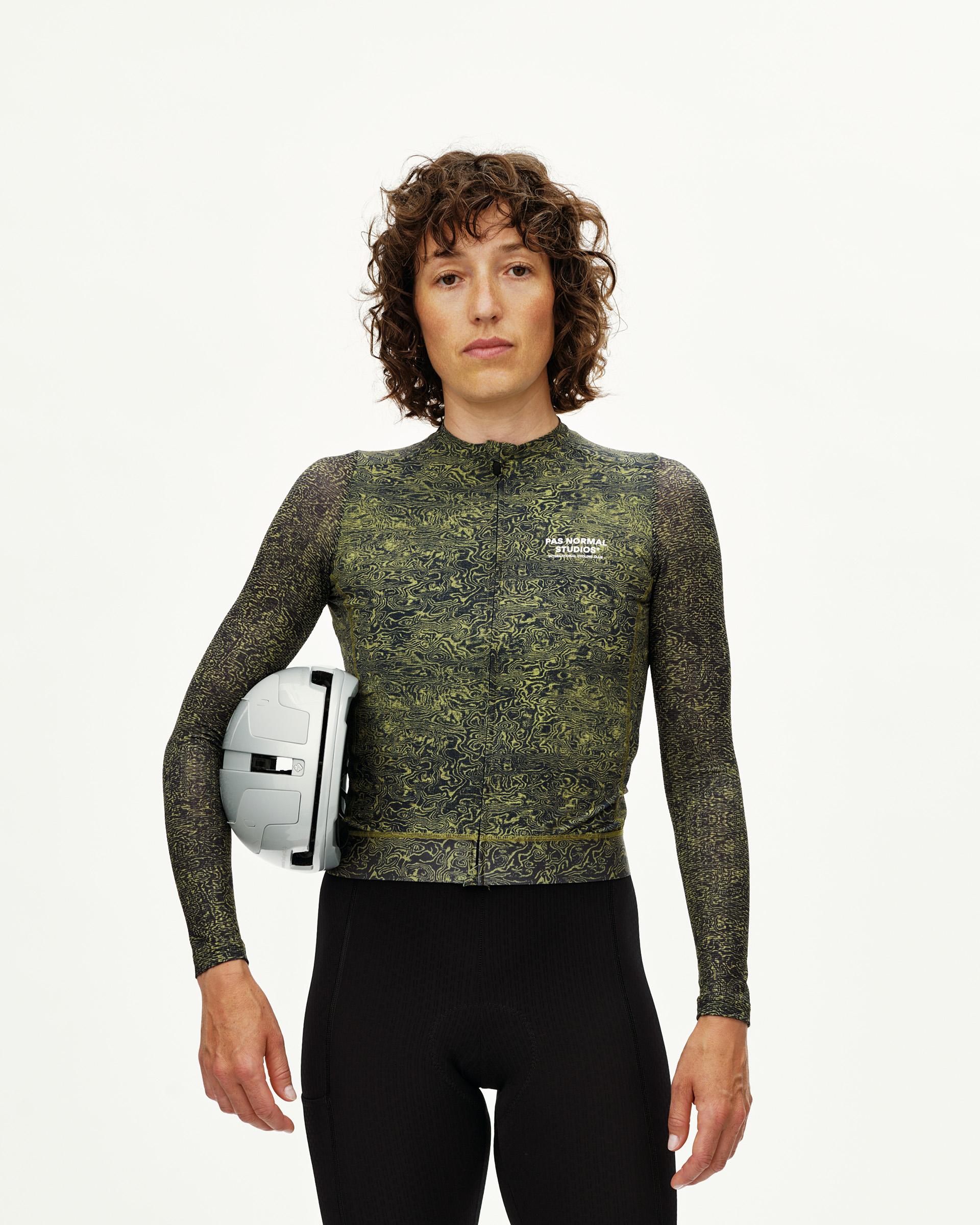 Dark Lime Essential long sleeve cycling jersey on model, front view with all-over swirl print