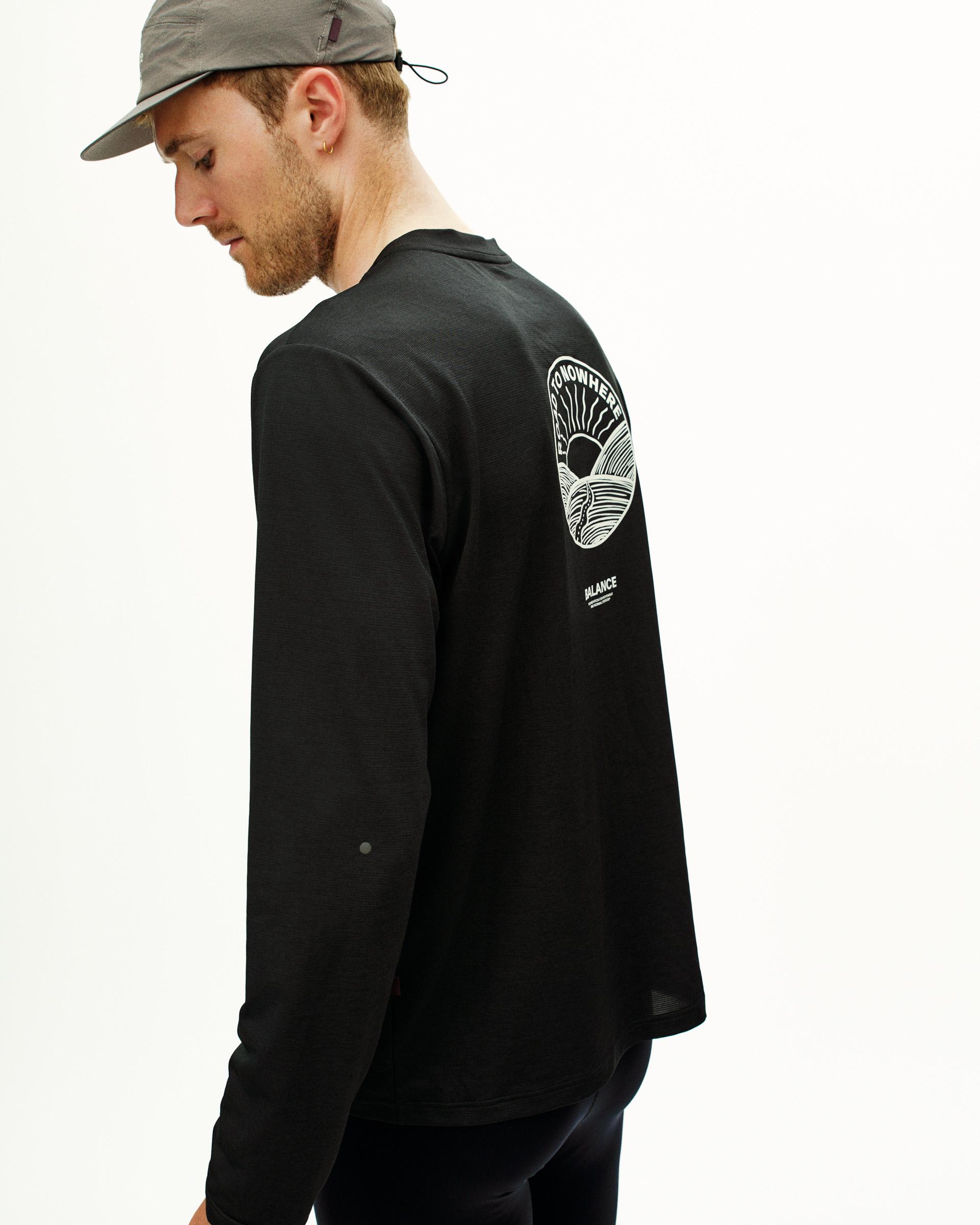 Black Balance long sleeve T-shirt on model, rear view with white landscape graphic print