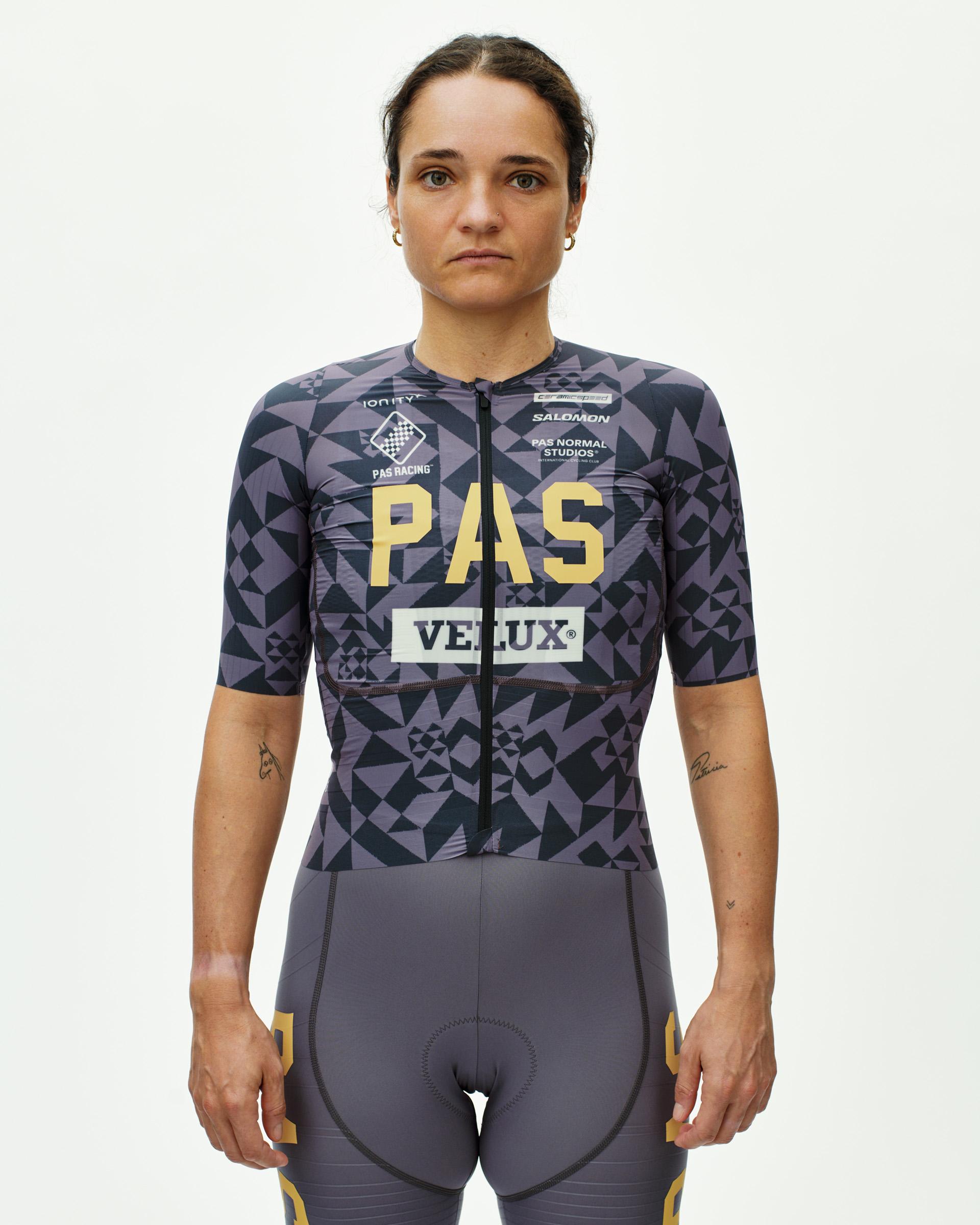 Origami Grey PAS Mechanism Pro women's cycling jersey on model, front view with geometric print and gold PAS chest graphic
