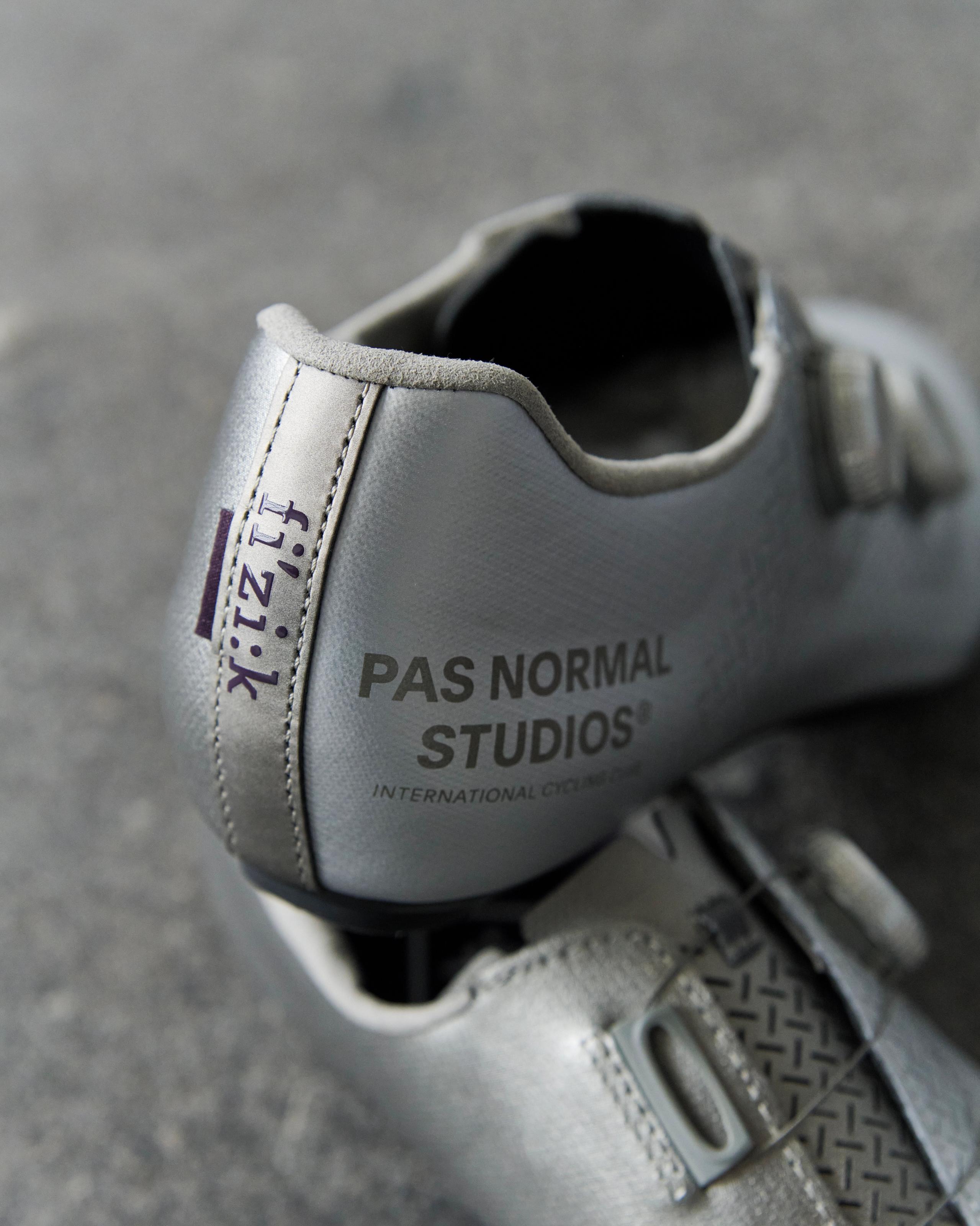 Silver Fizik Mechanism road cycling shoes, detail view of heel with branded tab