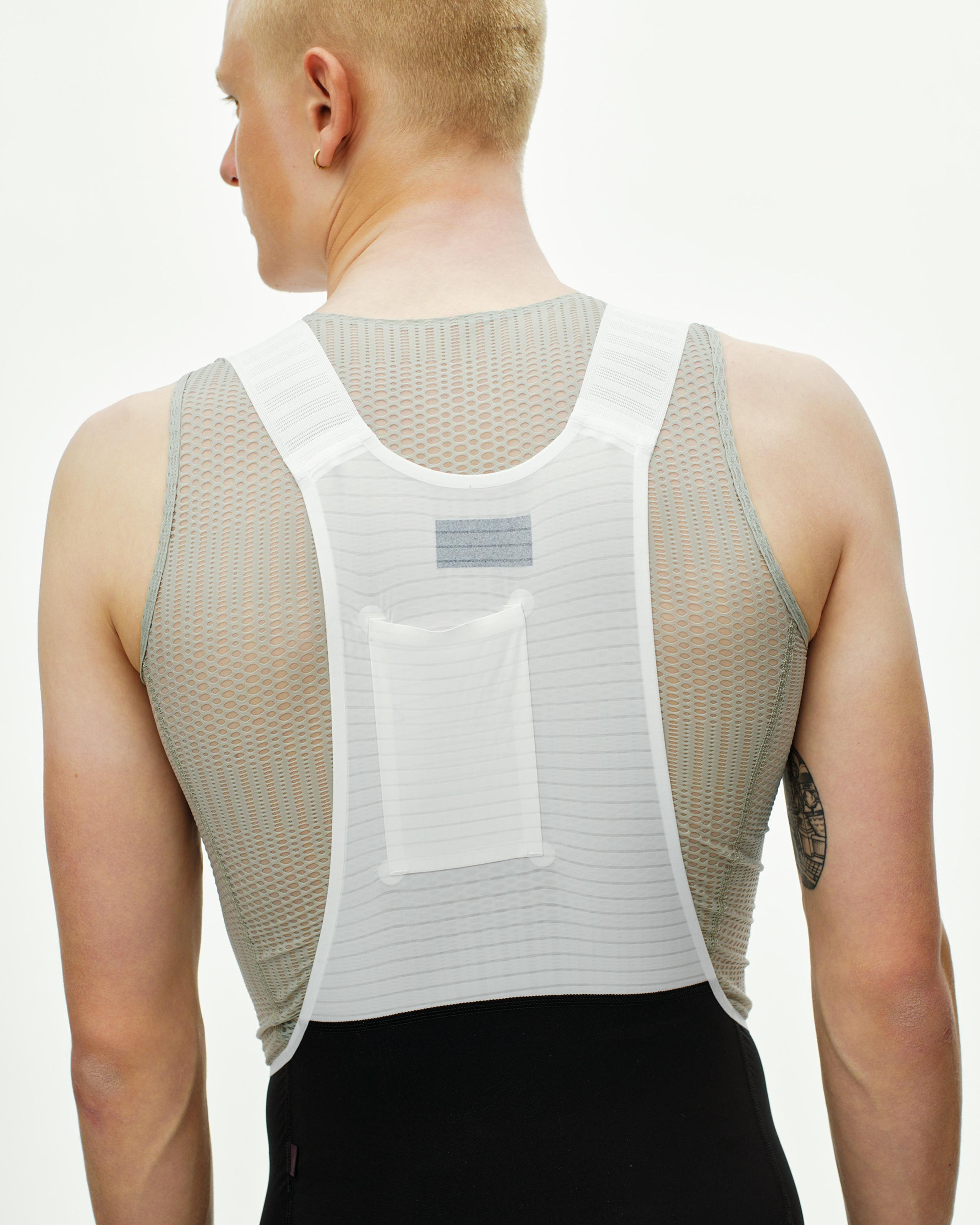 Black PAS Mechanism Pro cycling bibs on model, rear view with white mesh back panel and cargo pocket