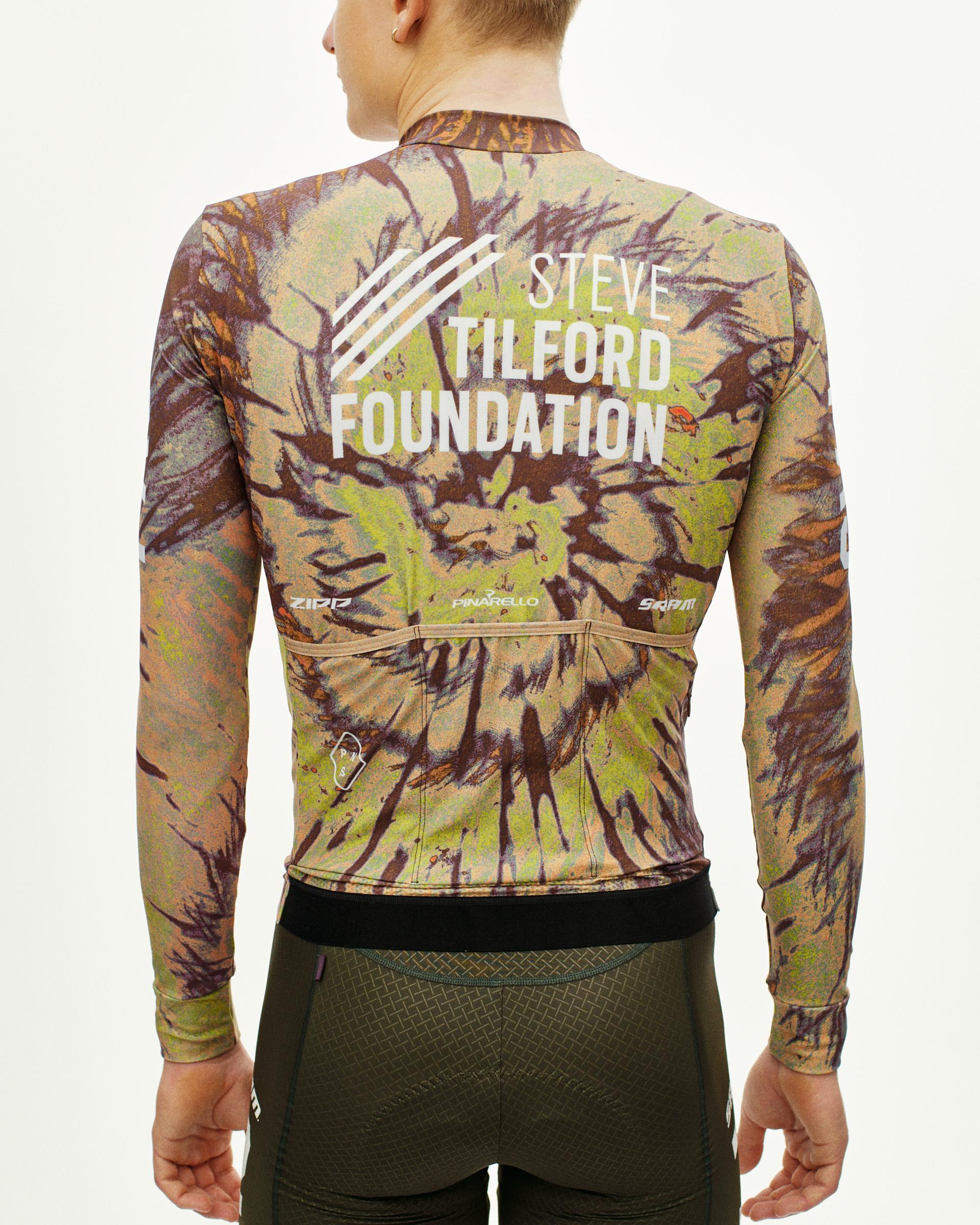 Beige STFR Mechanism long sleeve cycling jersey on model, rear view with Steve Tilford Foundation print