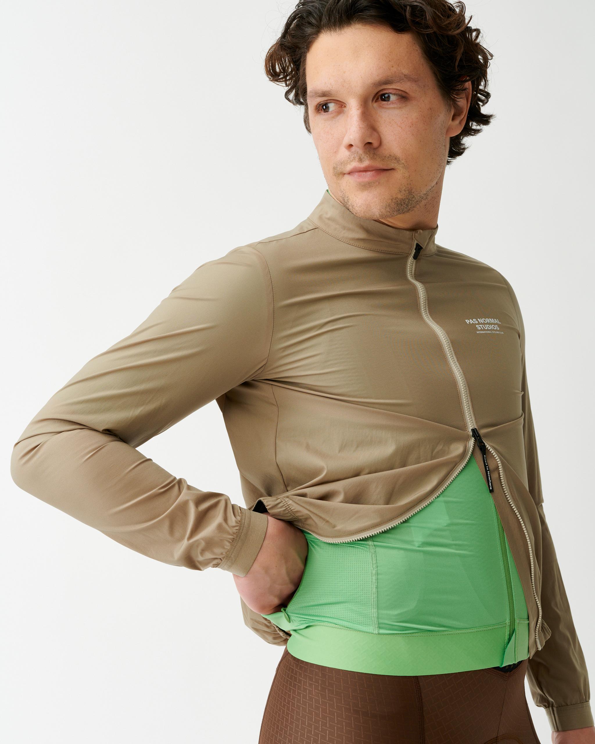 Beige Mechanism Stow Away jacket on model, front three-quarter view with full zip open