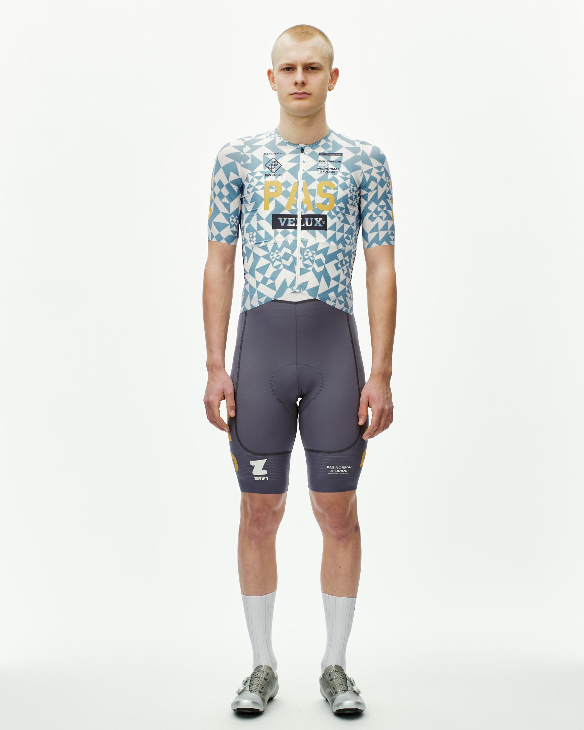 Origami Light Blue PAS Mechanism Pro cycling jersey on model, front view with geometric print and gold chest logo