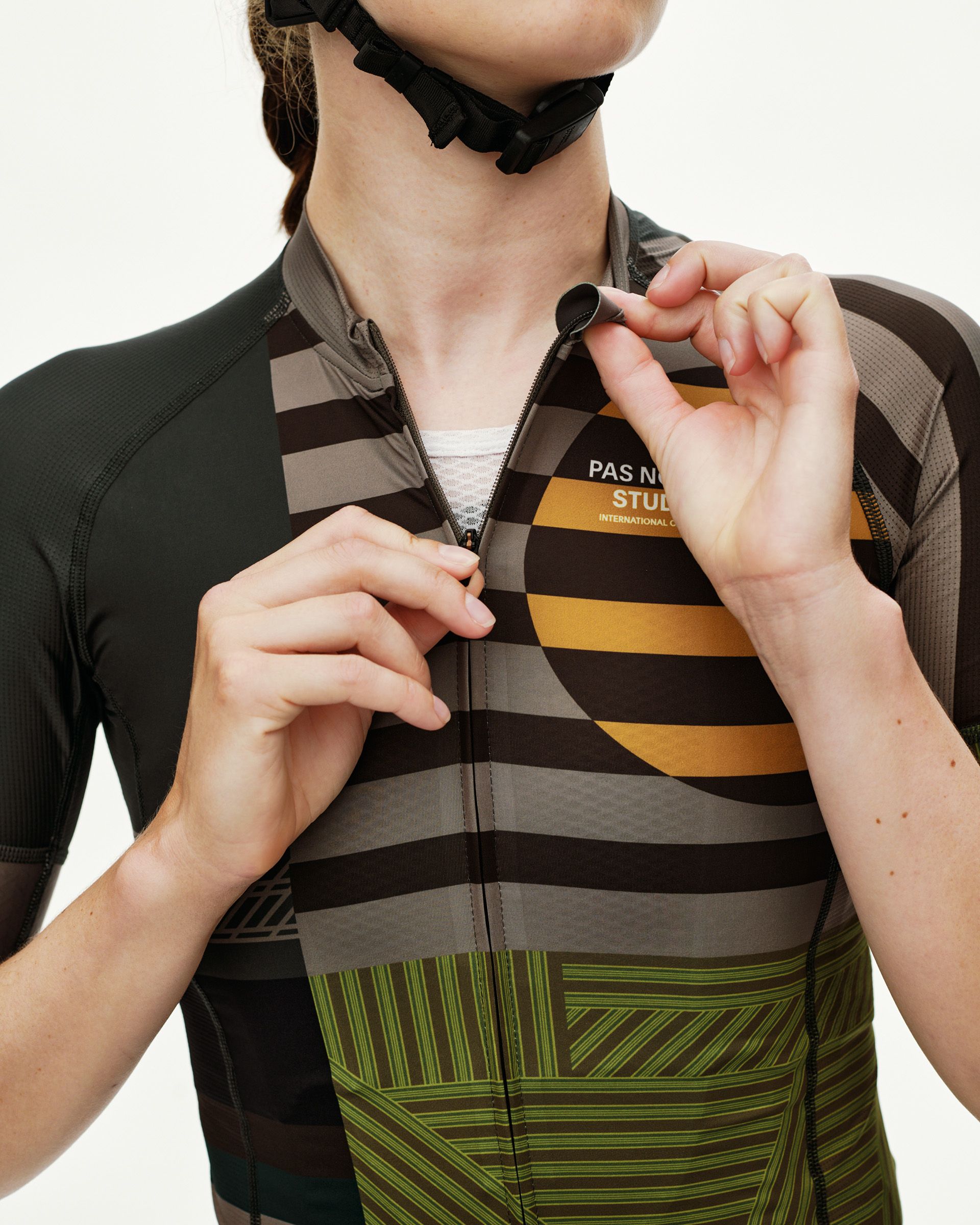 International Earth Mechanism women's cycling jersey, front detail on model with geometric stripe print and chest zip
