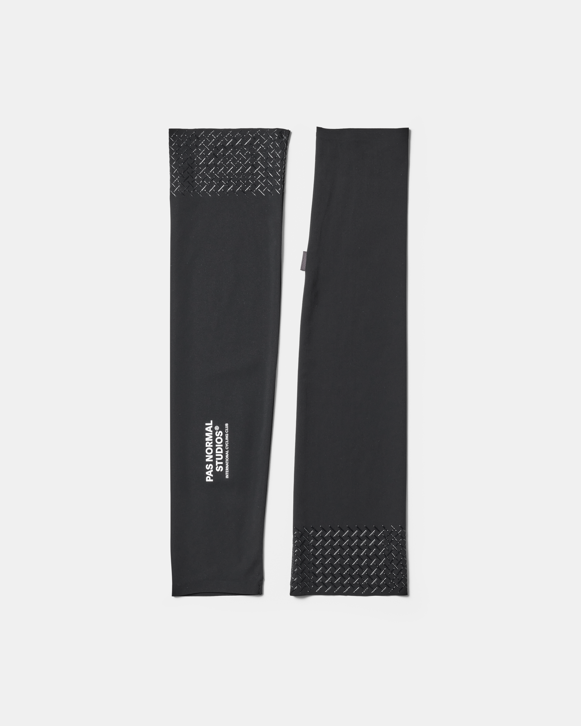 Black Logo Arm UV Protector arm warmers pair flat lay with textured grip panels