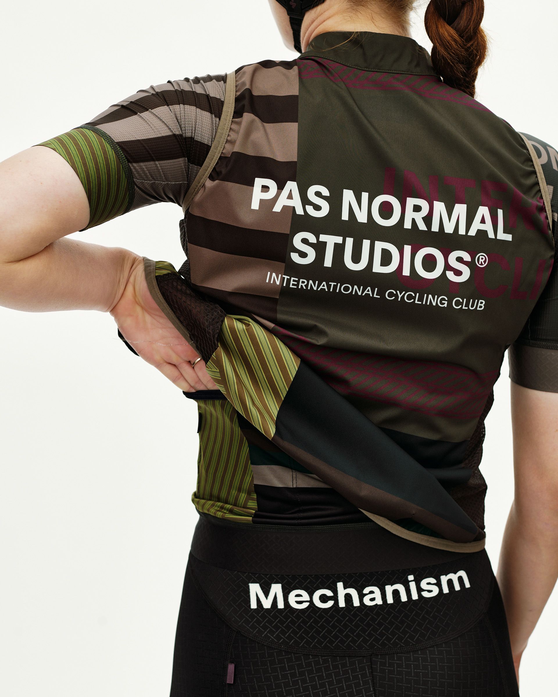 International Earth Mechanism Stow Away cycling gilet, rear view on model showing back pocket access