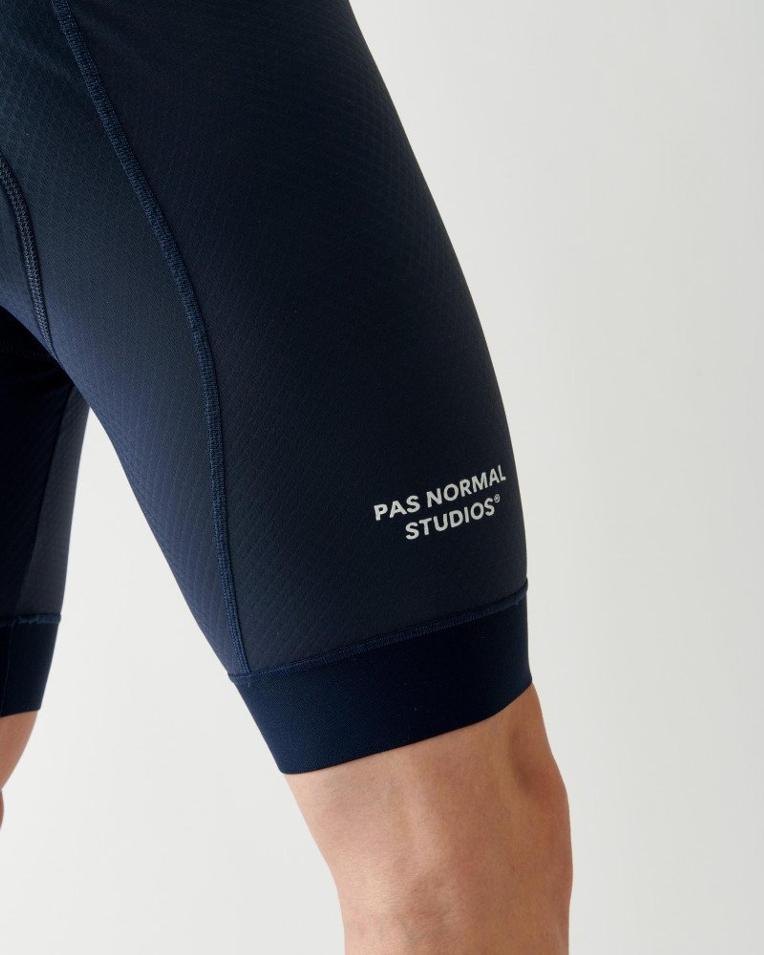 Navy Essential bibs, detail view on model showing contrast stitching and leg band
