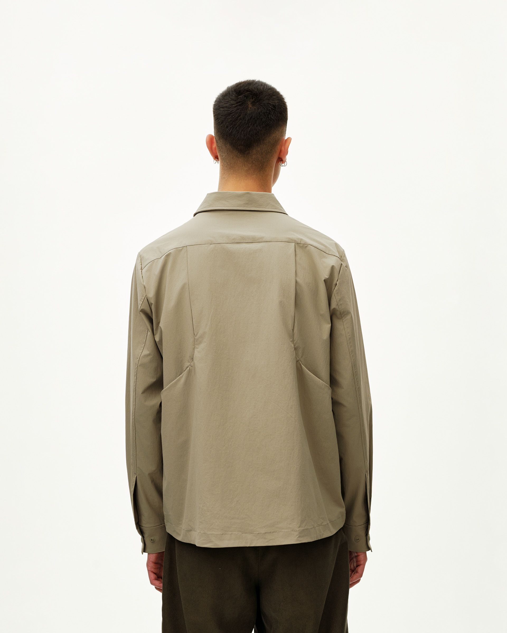 Dusty Earth khaki Off-Race Tech Overshirt on model, rear view with panelled back seaming