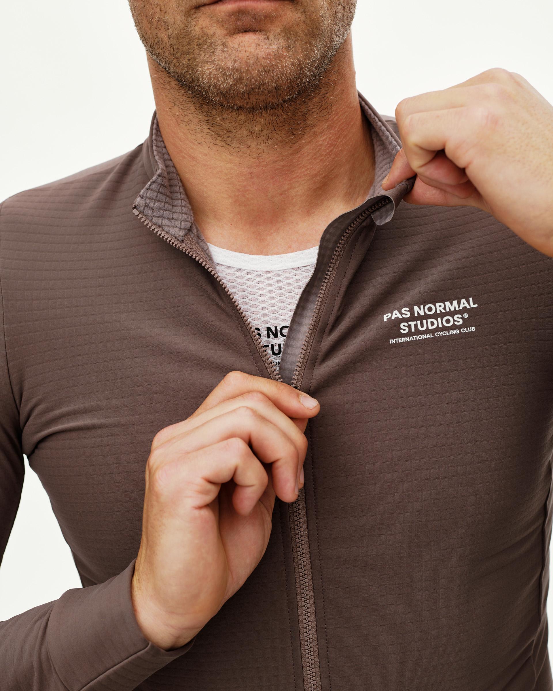 Dusty Plum Essential long sleeve cycling jersey, front detail on model with full zip open and white chest logo