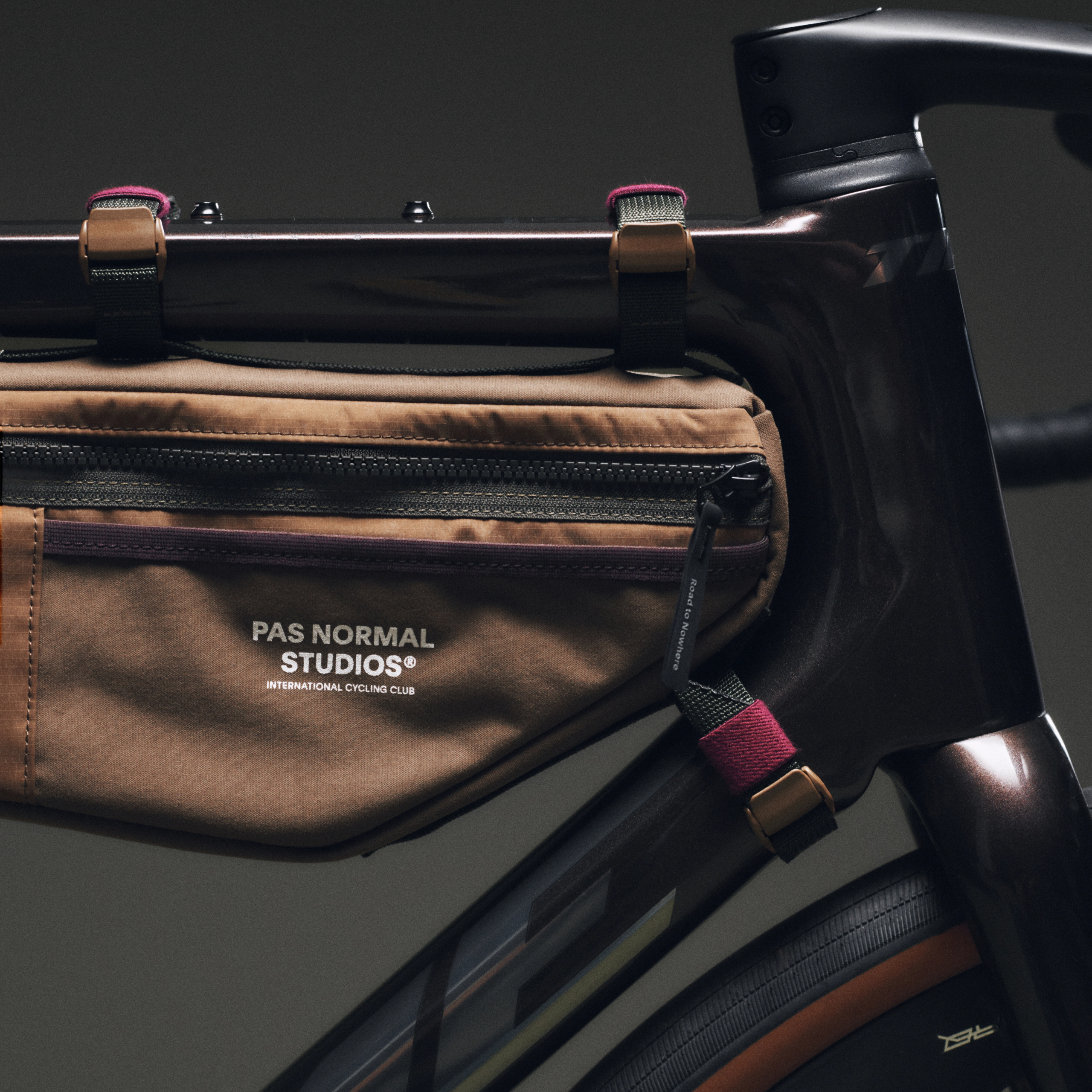 Tan Porter-Yoshida frame bag, detail view mounted on bike frame with black zip and branded logo patch