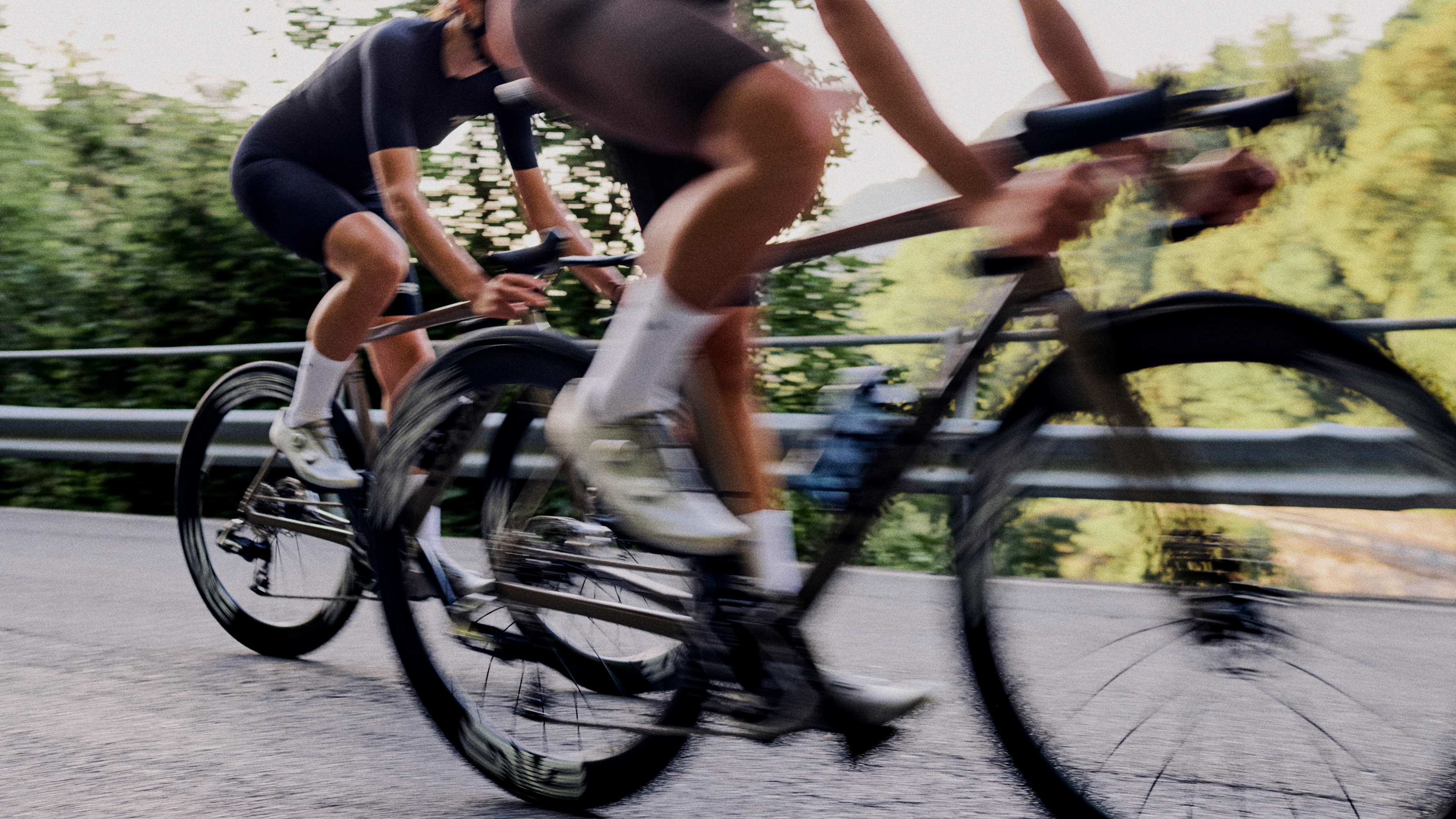 Cyclists in motion blur racing on road bikes