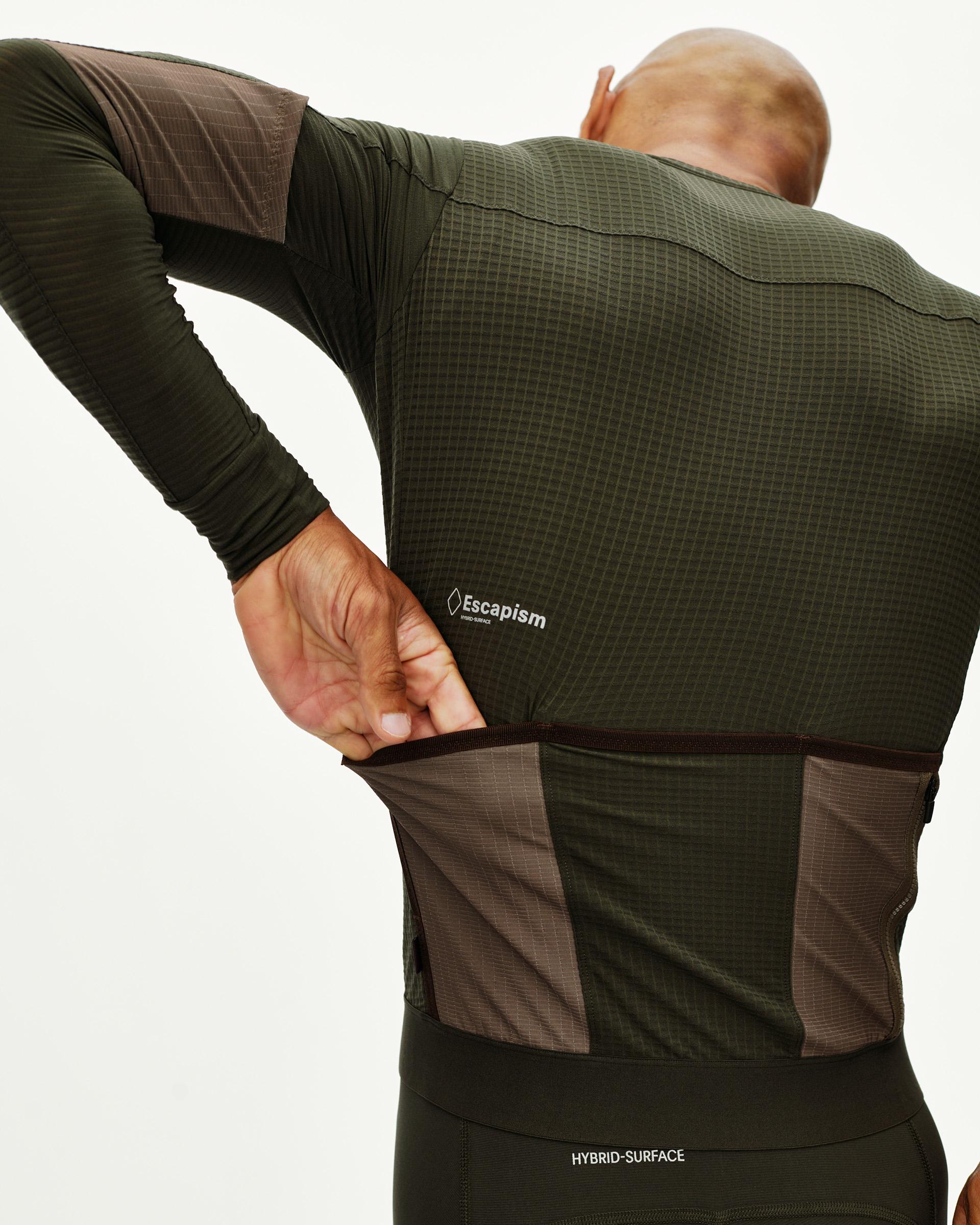 Dark Olive Escapism long sleeve cycling jersey on model, rear view with contrast dark panel and grid texture