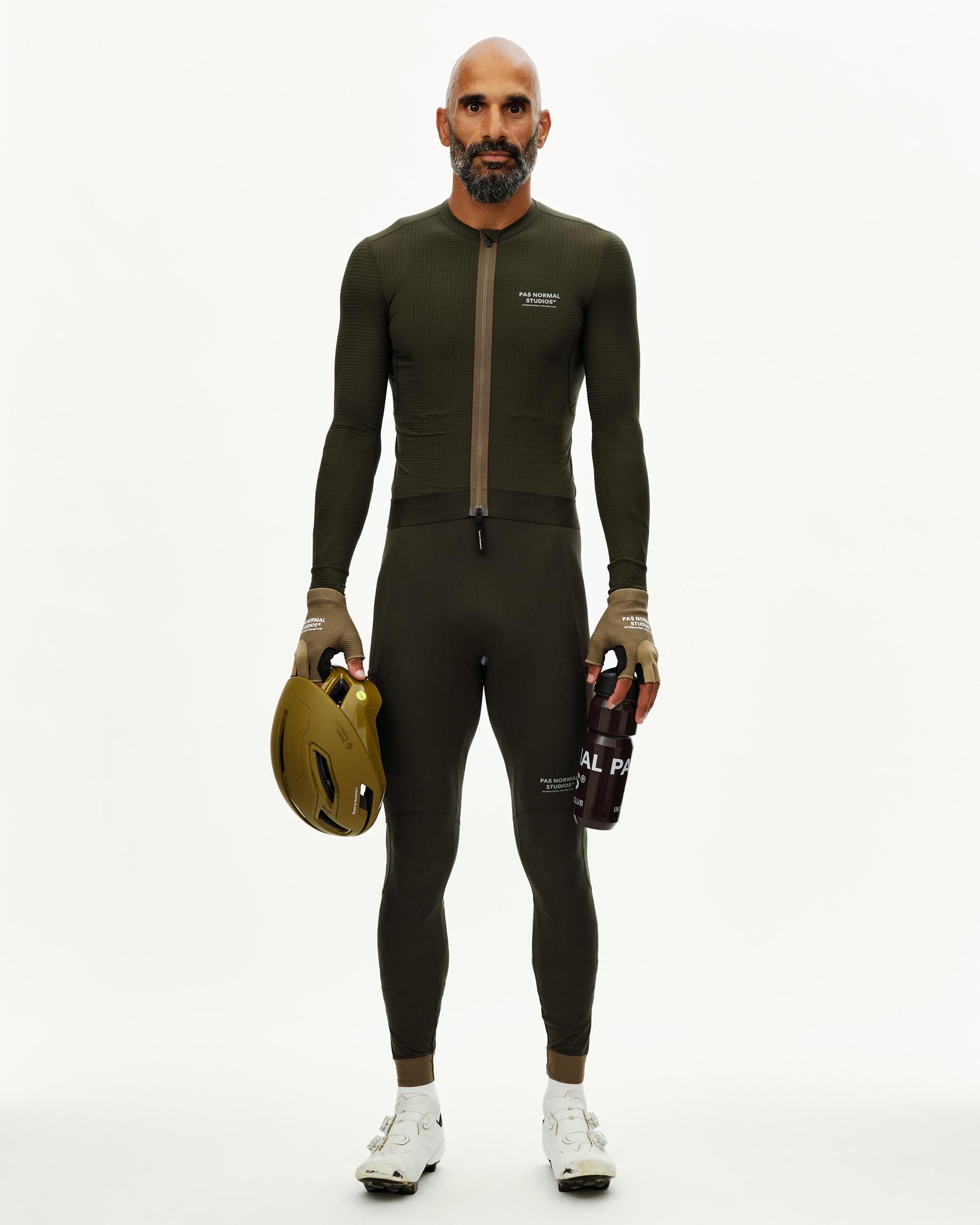 Dark Olive Escapism long sleeve cycling jersey on model, front view with textured fabric and chest logo print