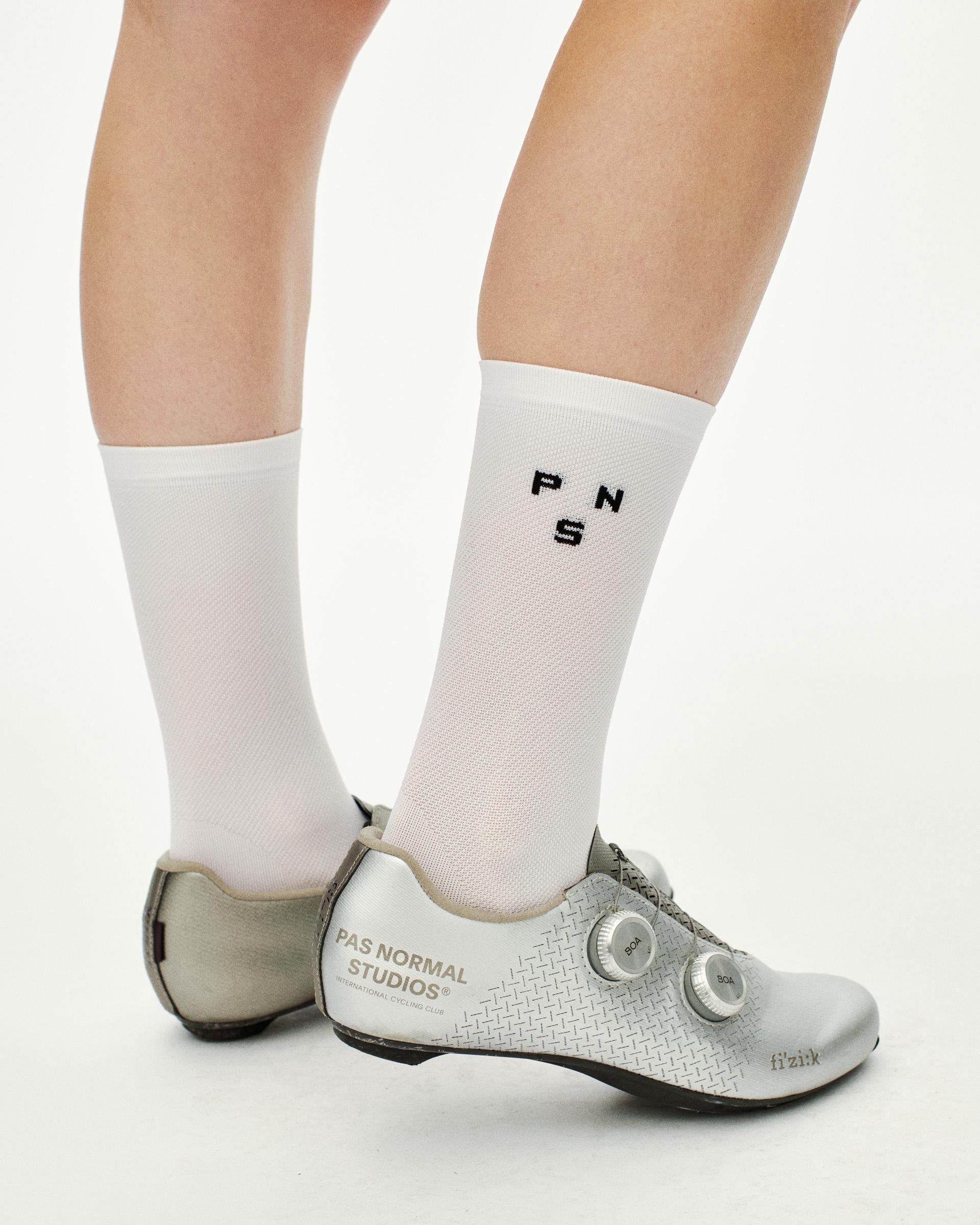 White Essential Lightweight cycling socks on model with black PNS logo
