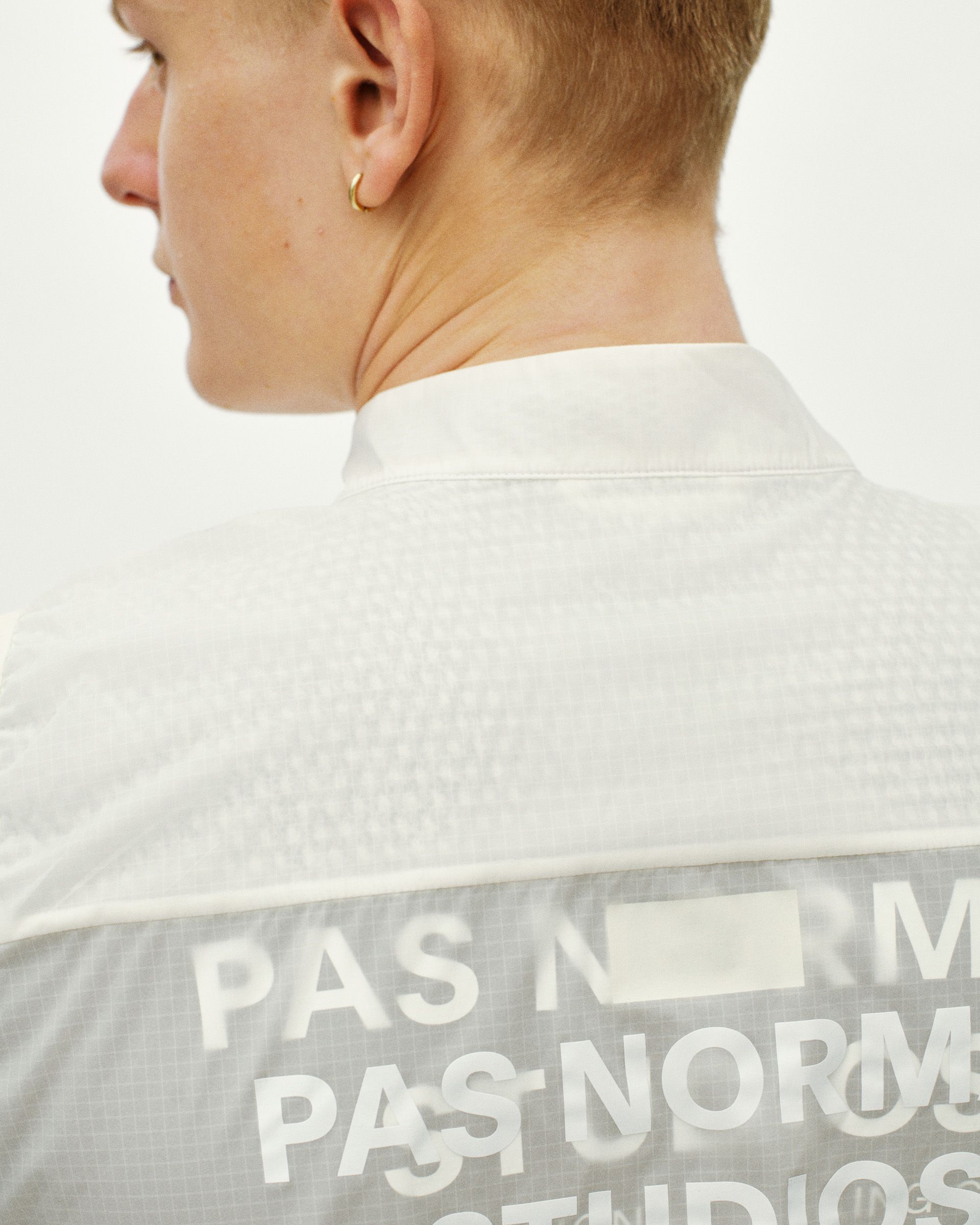 Off White Essential Insulated gilet on model, rear view with large white branded text panel