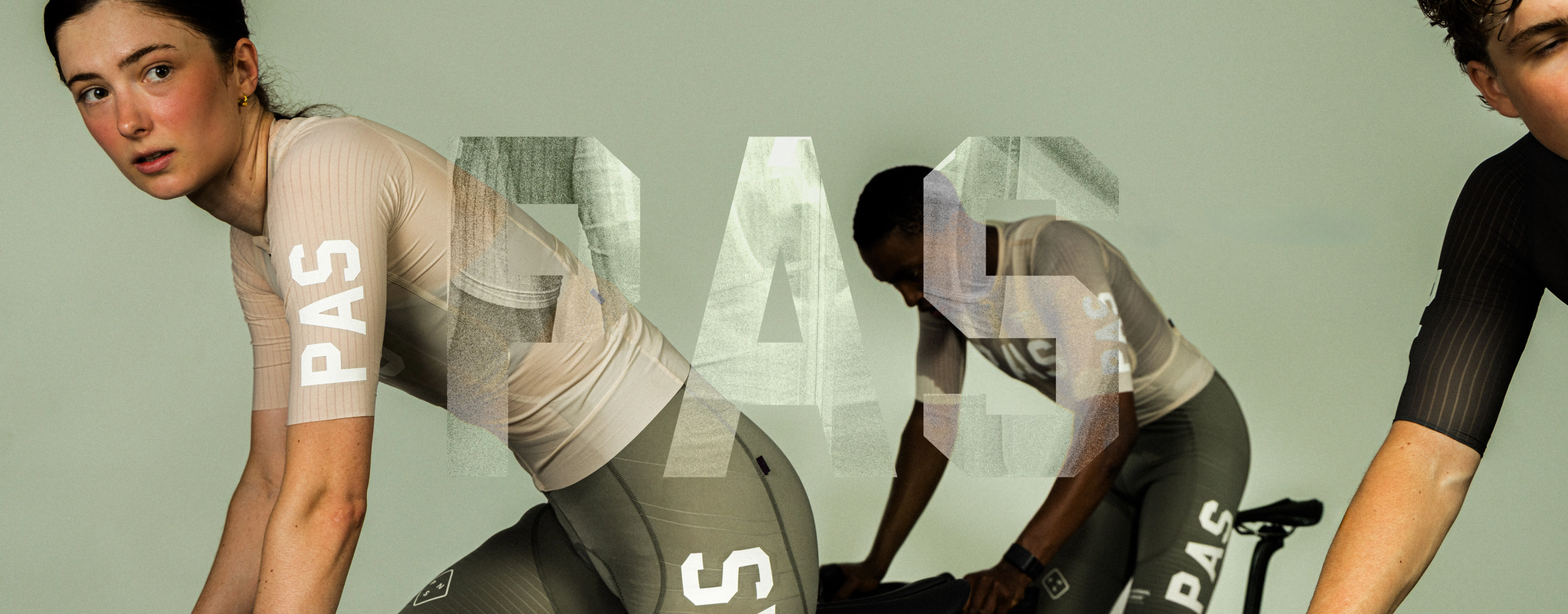 Models wearing beige and black cycling jerseys with white lettering from PAS collection