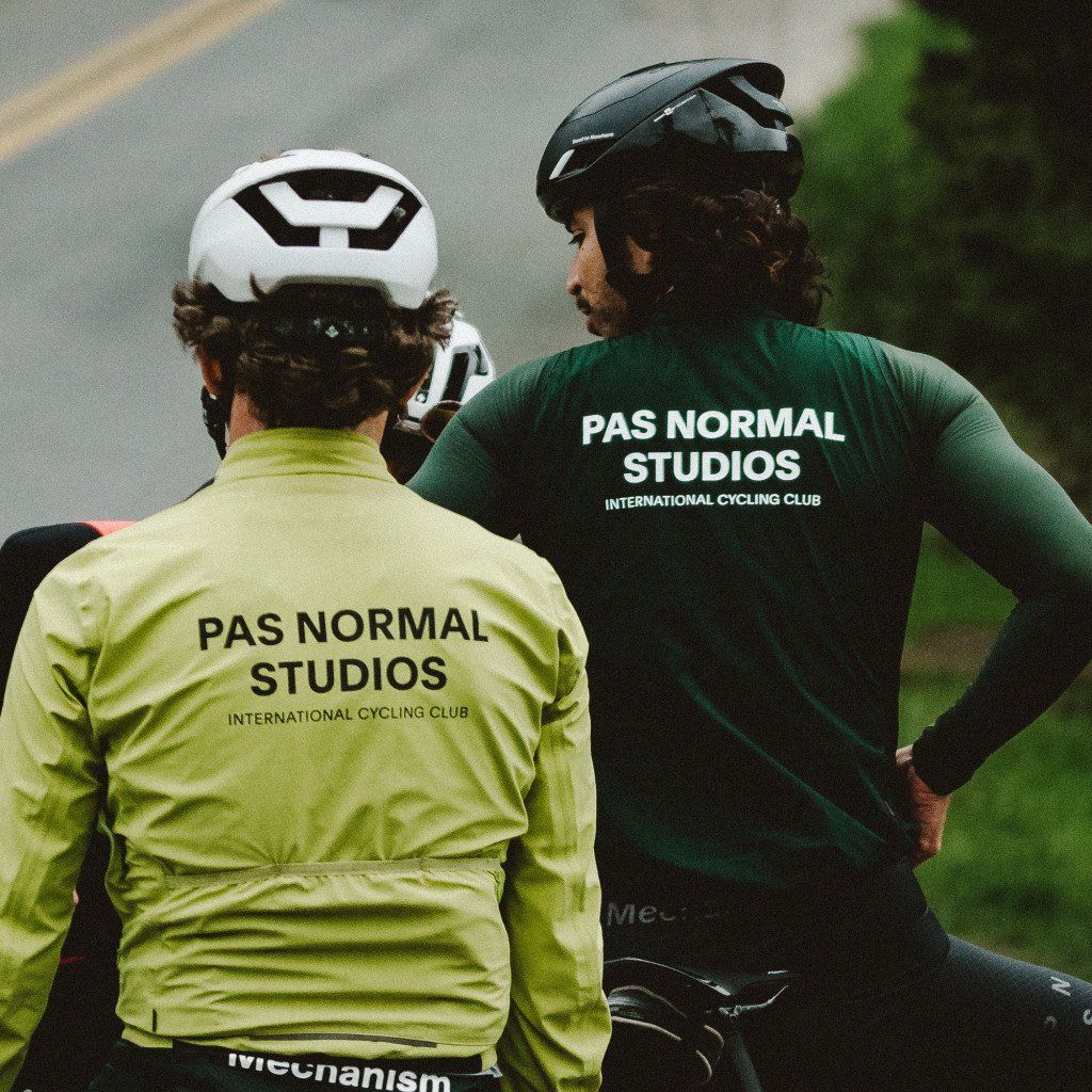 Models wearing long sleeve cycling jerseys with back logo in yellow and green on road