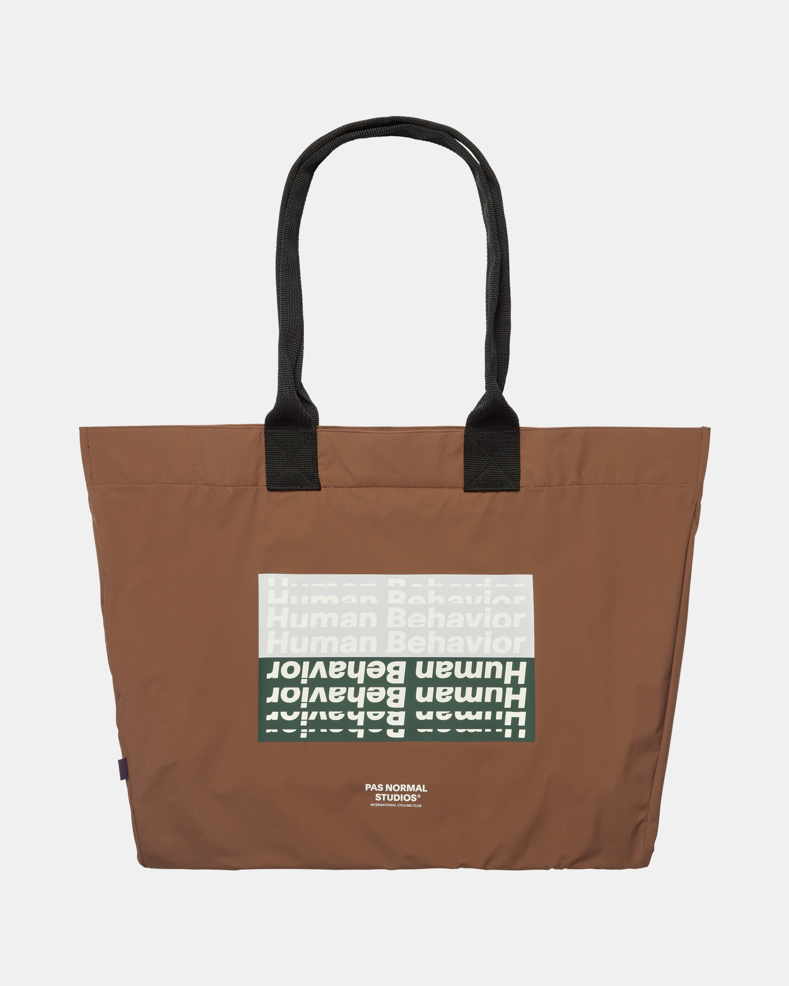 Hazel brown T.K.O. Shield Tote Bag, front flat lay with repeated Human Behavior graphic print
