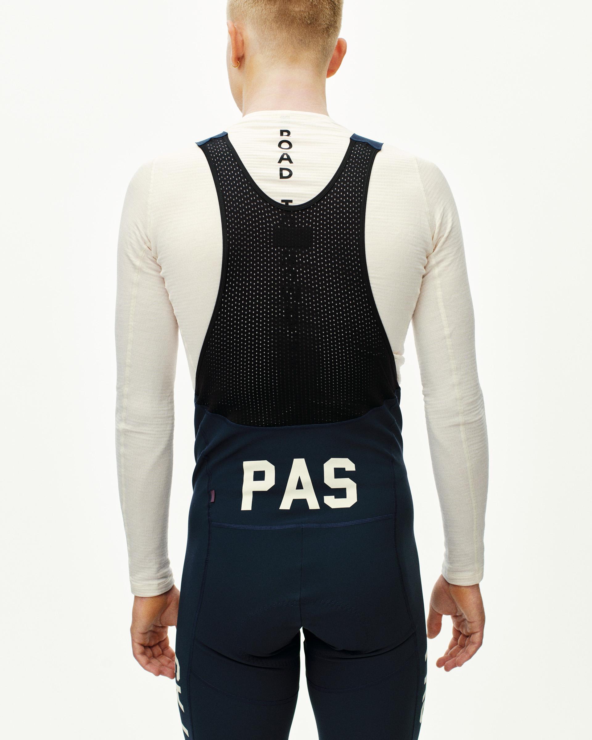 Navy PAS Mechanism Deep Winter Long cycling bibs on model, rear view with mesh bib panel