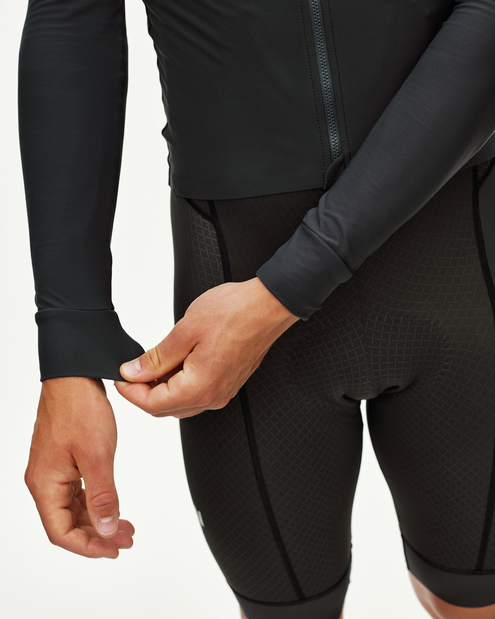 Dark Navy Mechanism long sleeve cycling jersey on model, side detail view with ribbed cuff