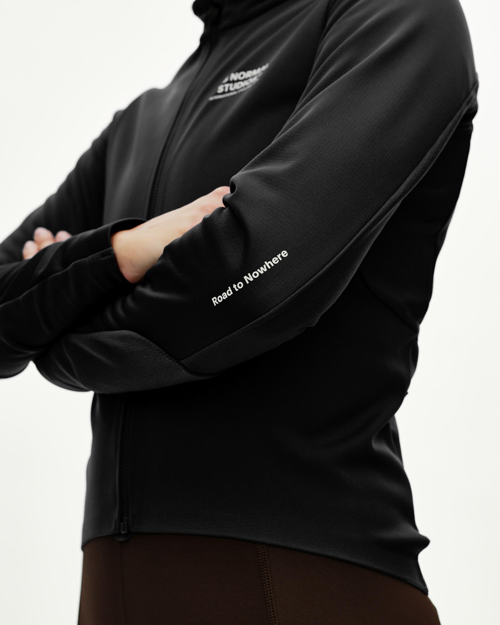 Black Mechanism Thermal Long Sleeve Jersey 2.0 cycling jersey on model, detail view with white Road to Nowhere sleeve print