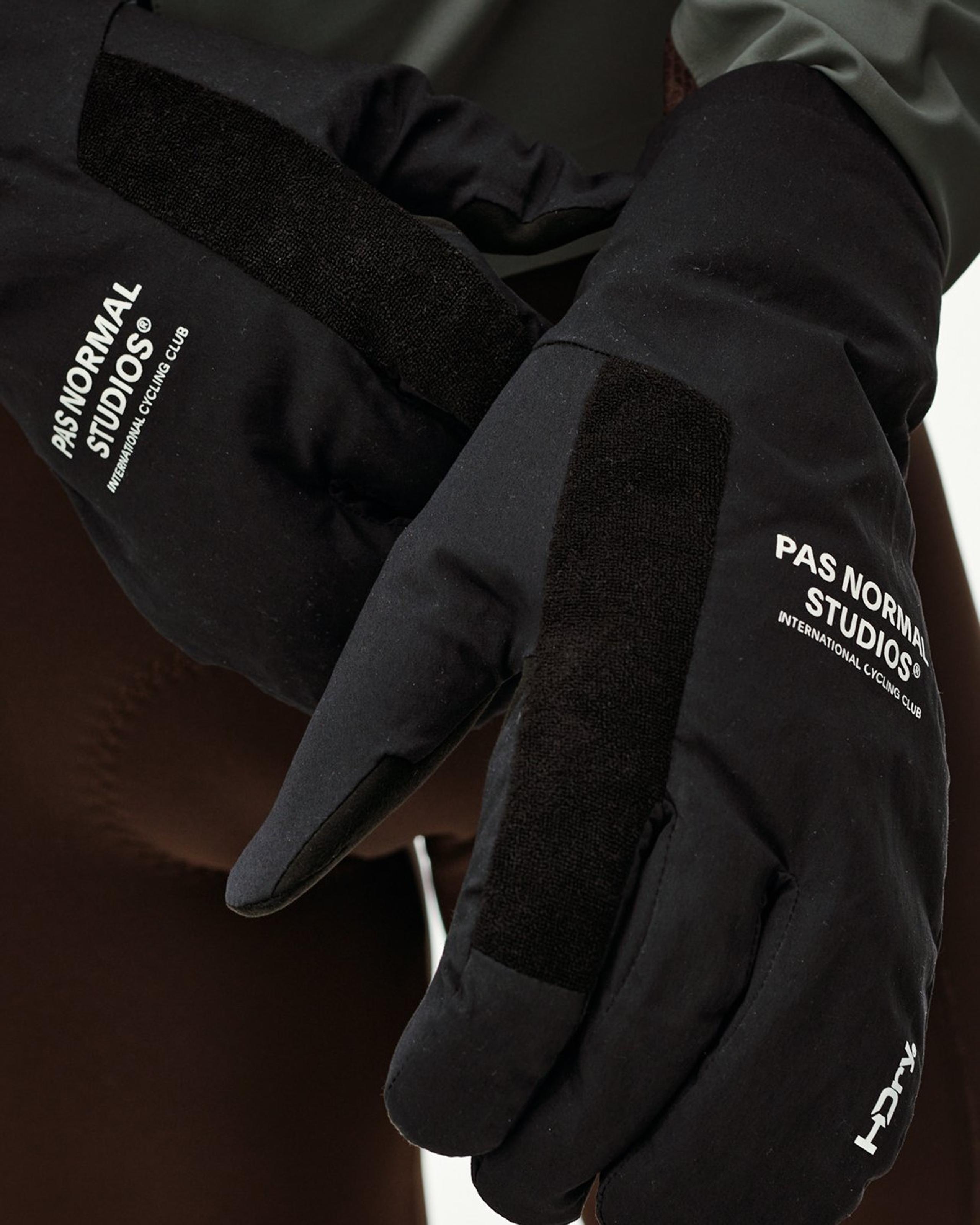 Black Logo Deep Winter Insulated cycling gloves on model, front detail view with white logo print and velcro strap