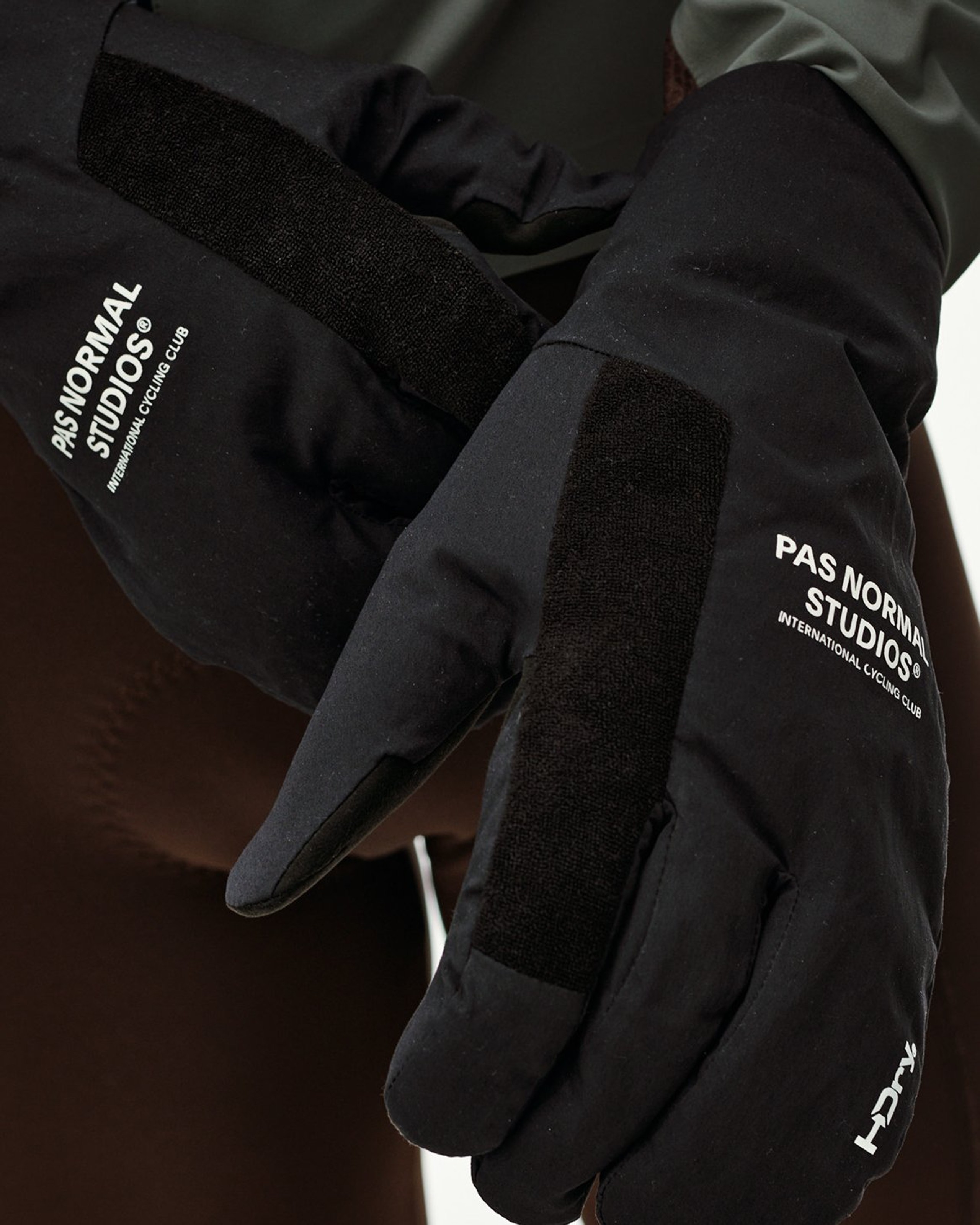 Black Logo Deep Winter Insulated cycling gloves on model, front detail view with white logo print and velcro strap