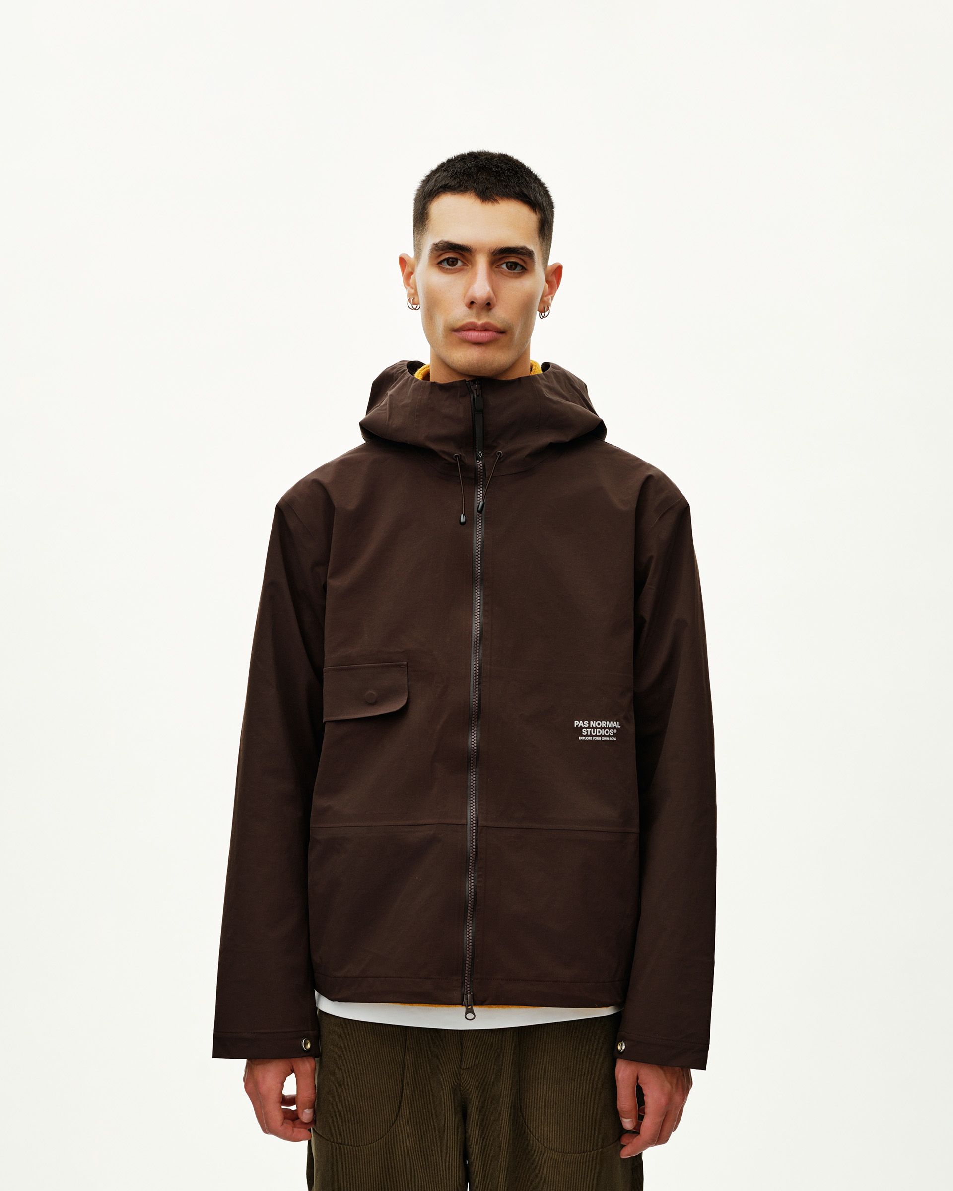 Dark Coffee brown Off-Race 3L Shell jacket on model, front view with chest patch pocket and full zip