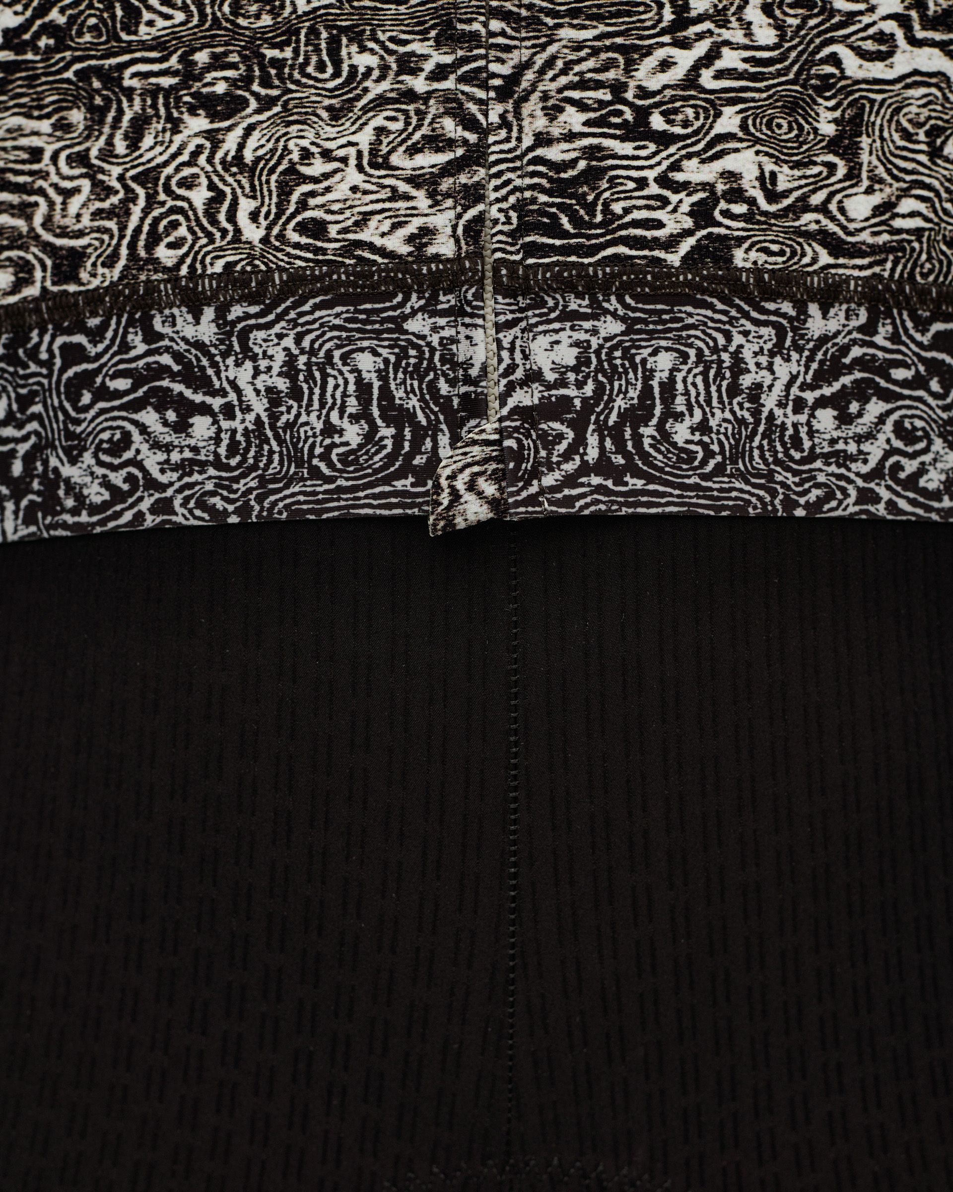 Off White Essential women's cycling jersey, detail view showing abstract black and white print upper with black ribbed lower