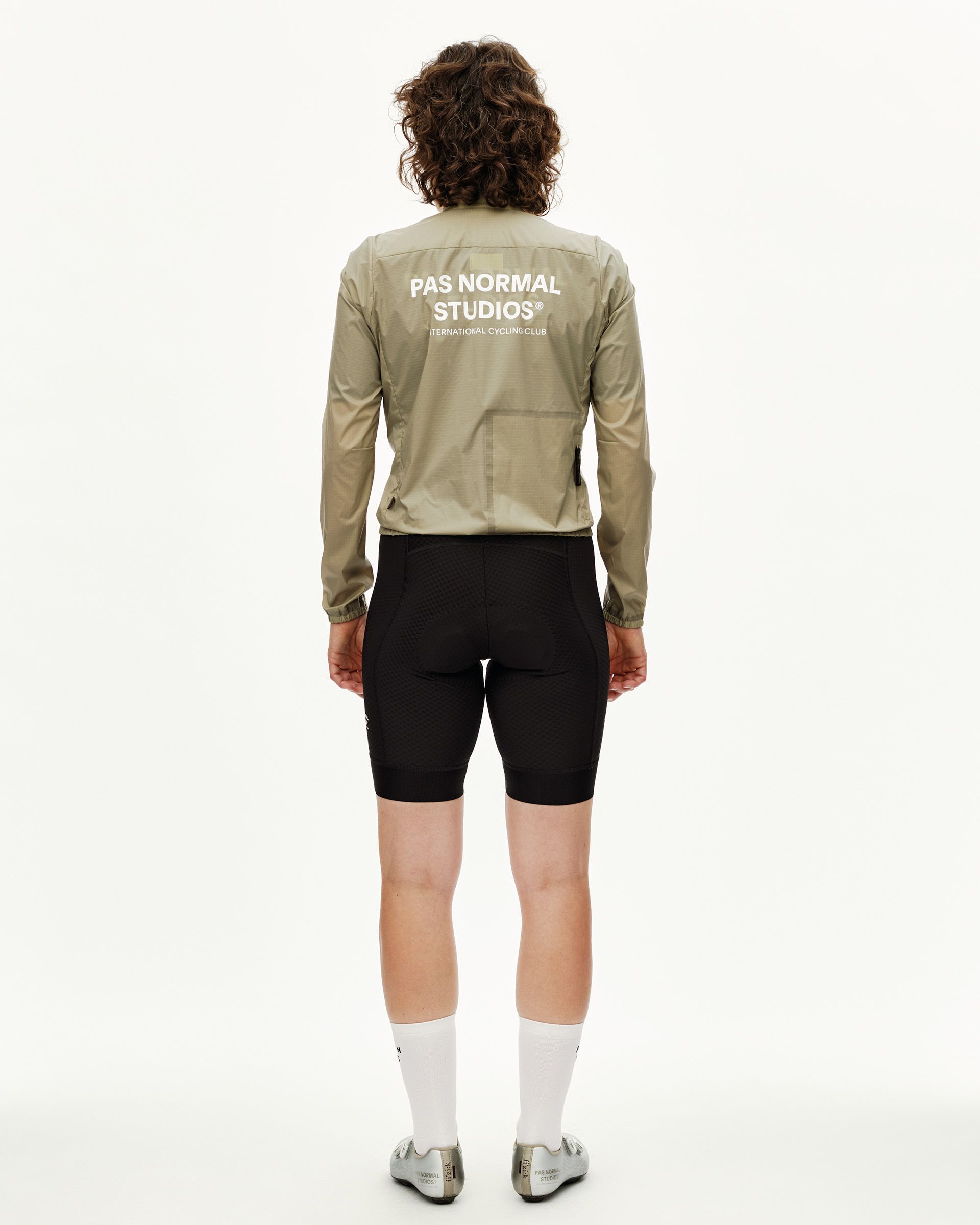 Grey Sage Essential Insulated cycling jacket on model, rear view with white back logo print