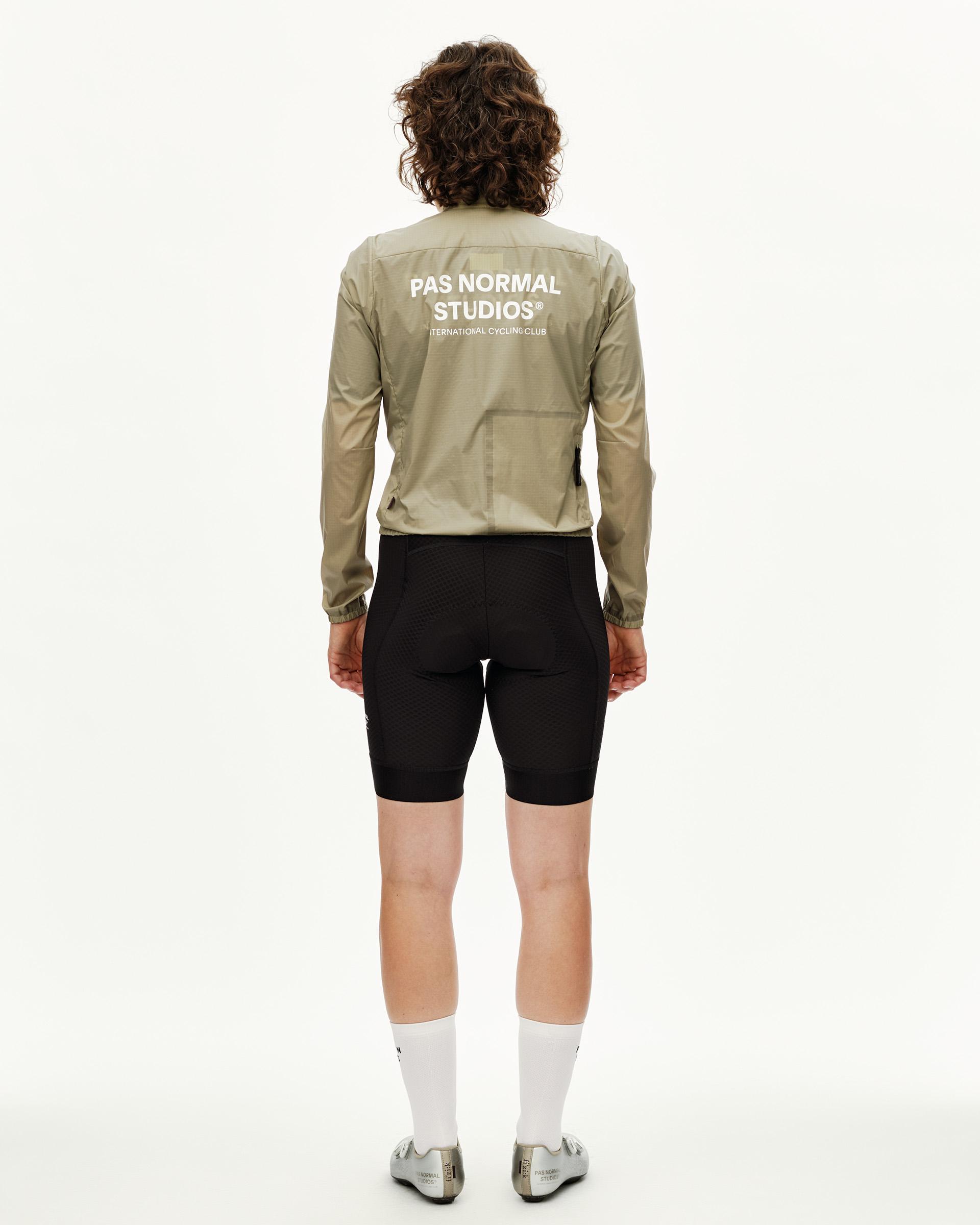 Grey Sage Essential Insulated cycling jacket on model, rear view with white back logo print
