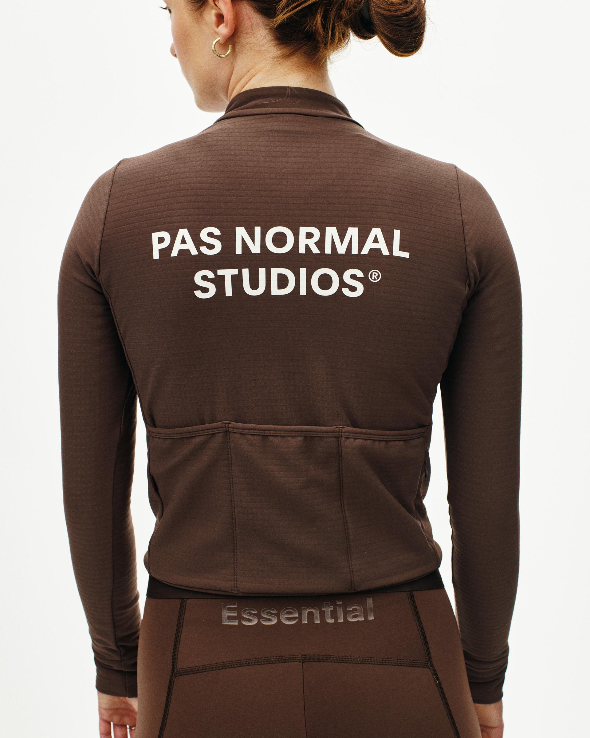 Light Brown Essential women's long sleeve cycling jersey on model, rear view with white back print and rear pockets