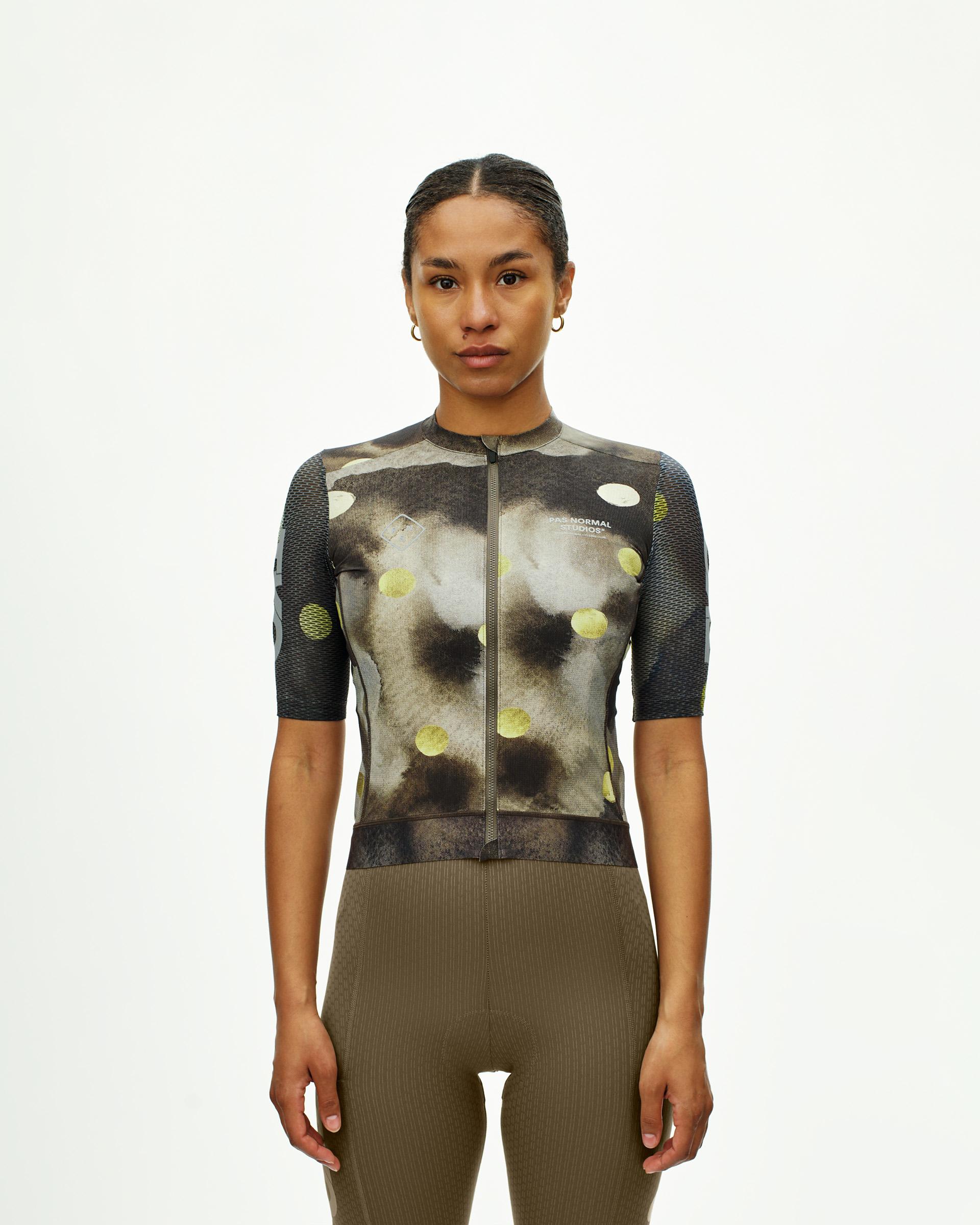 Green T.K.O. Essential Light cycling jersey on model with abstract print and mesh sleeves