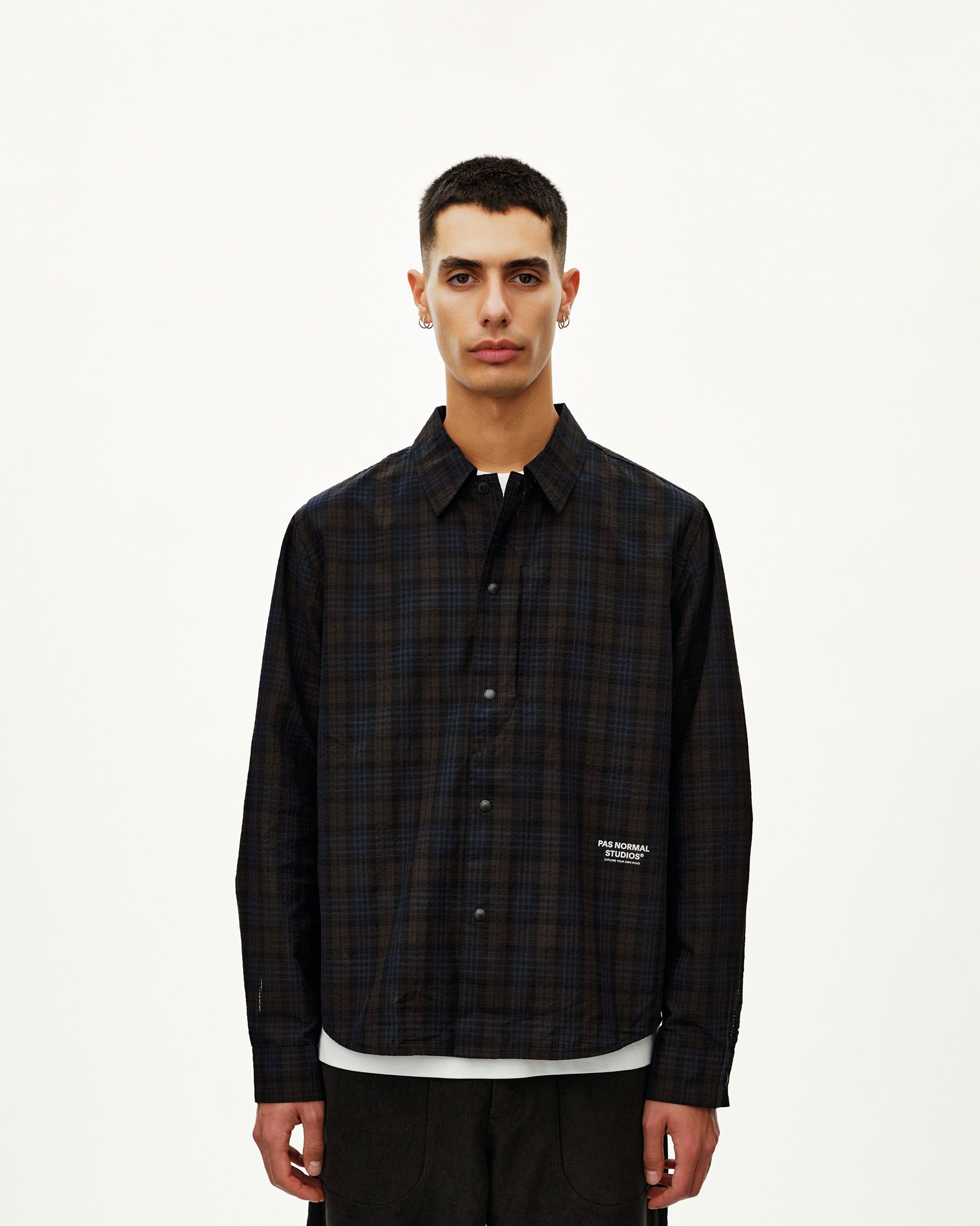 Dark Navy Off-Race Seersucker shirt, front view on model with dark plaid pattern and snap button placket