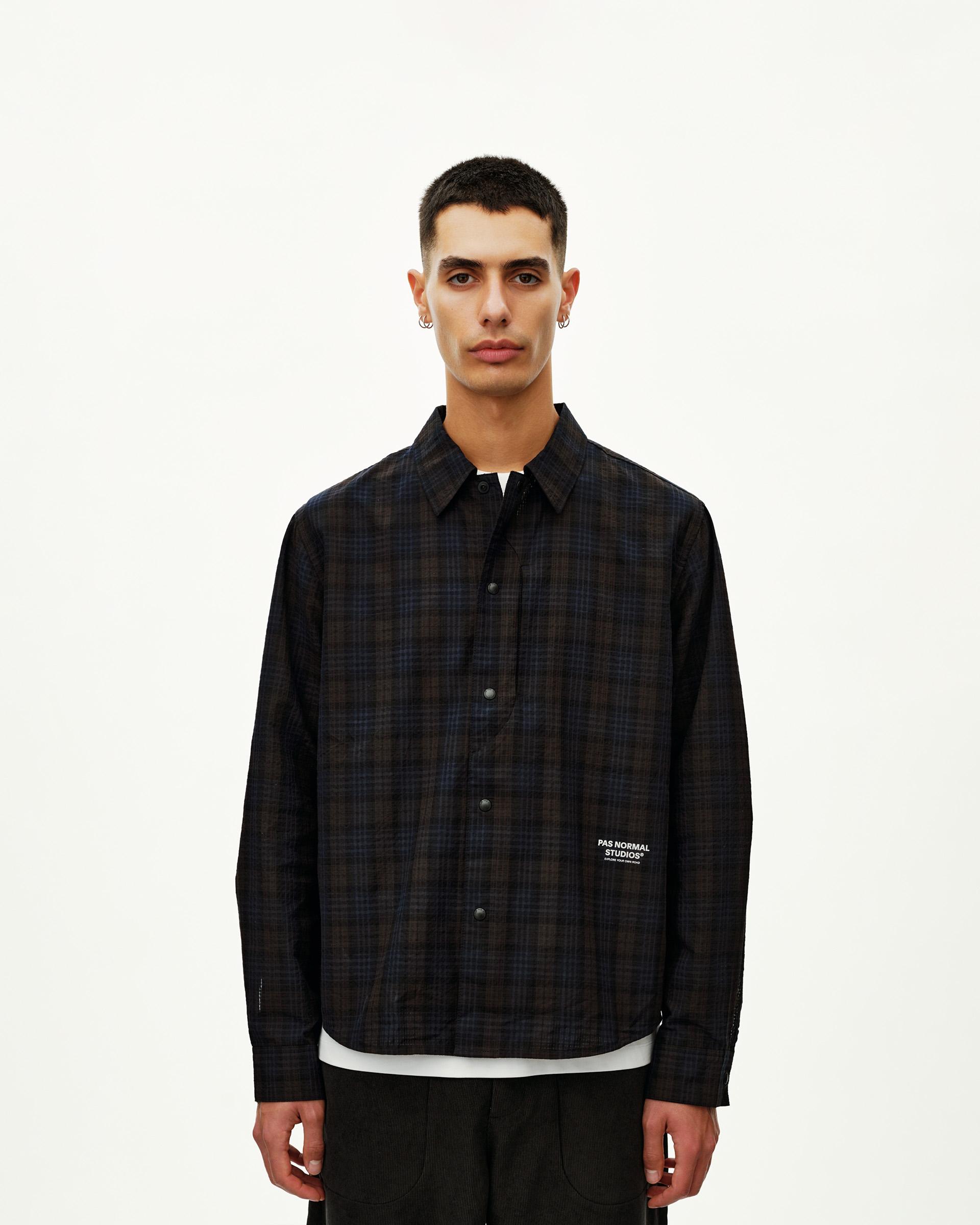 Dark Navy Off-Race Seersucker shirt, front view on model with dark plaid pattern and snap button placket