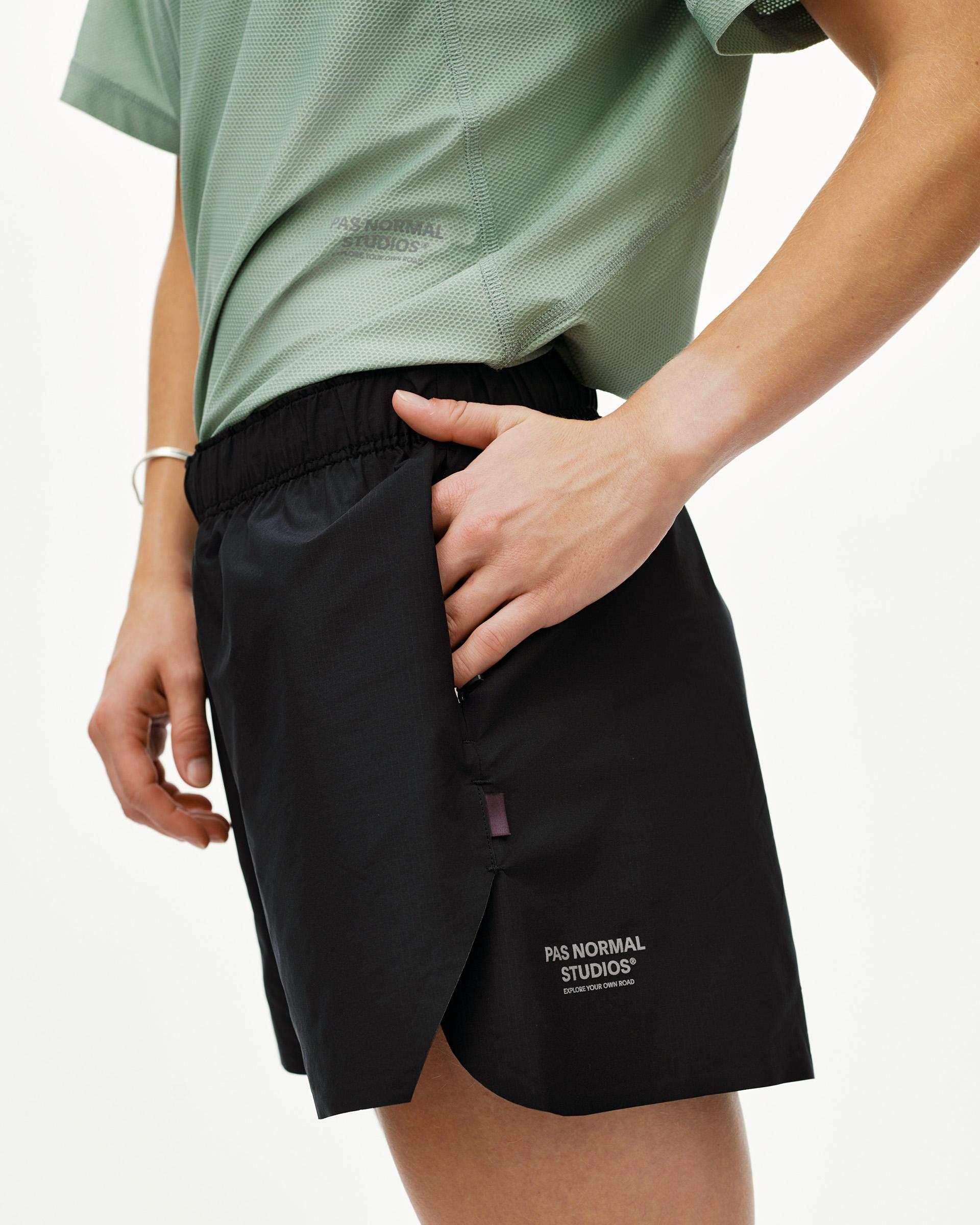Black Balance shorts on model, side view with elasticated waistband and side pocket