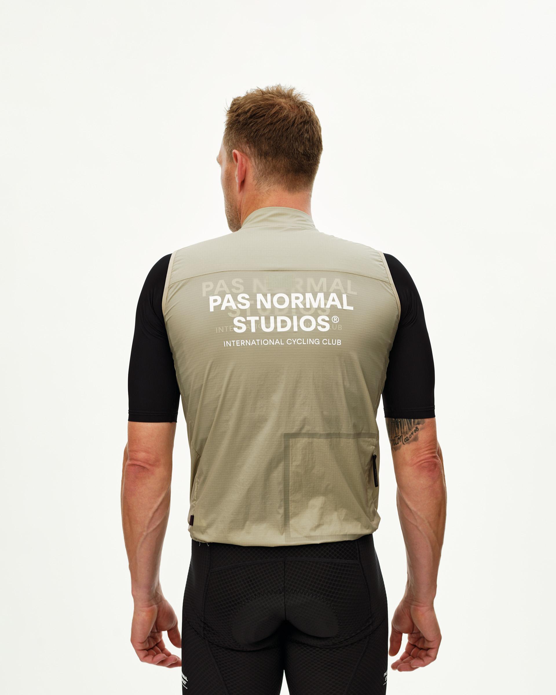 Grey Sage Essential cycling gilet on model, rear view with white chest logo print